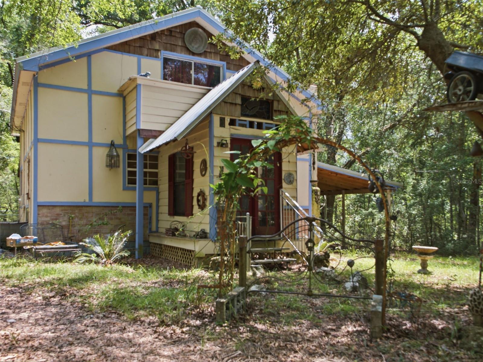 Escape to the peace and privacy of country living on 4.78 wooded acres in Trenton! This unique 3-bedroom, 1-bath home is tucked away among mature trees and offers the perfect opportunity for a homestead, investment property, or private country retreat. Inside, you'll find a cozy layout with rustic charm and ample living space ready for your personal touches. The spacious 4.78-acre homesite provides plenty of room for gardening, animals, equipment, RVs, and outdoor hobbies. Several outbuildings and covered storage areas offer additional flexibility for tools, projects, and recreational vehicles. Enjoy the freedom and privacy of rural North Florida while remaining just a short drive from local shopping, dining, schools, and the Suwannee River. Whether you're looking to renovate, invest, or create your own country sanctuary, this property offers endless potential. No HOA. Buyer to verify all information and measurements.