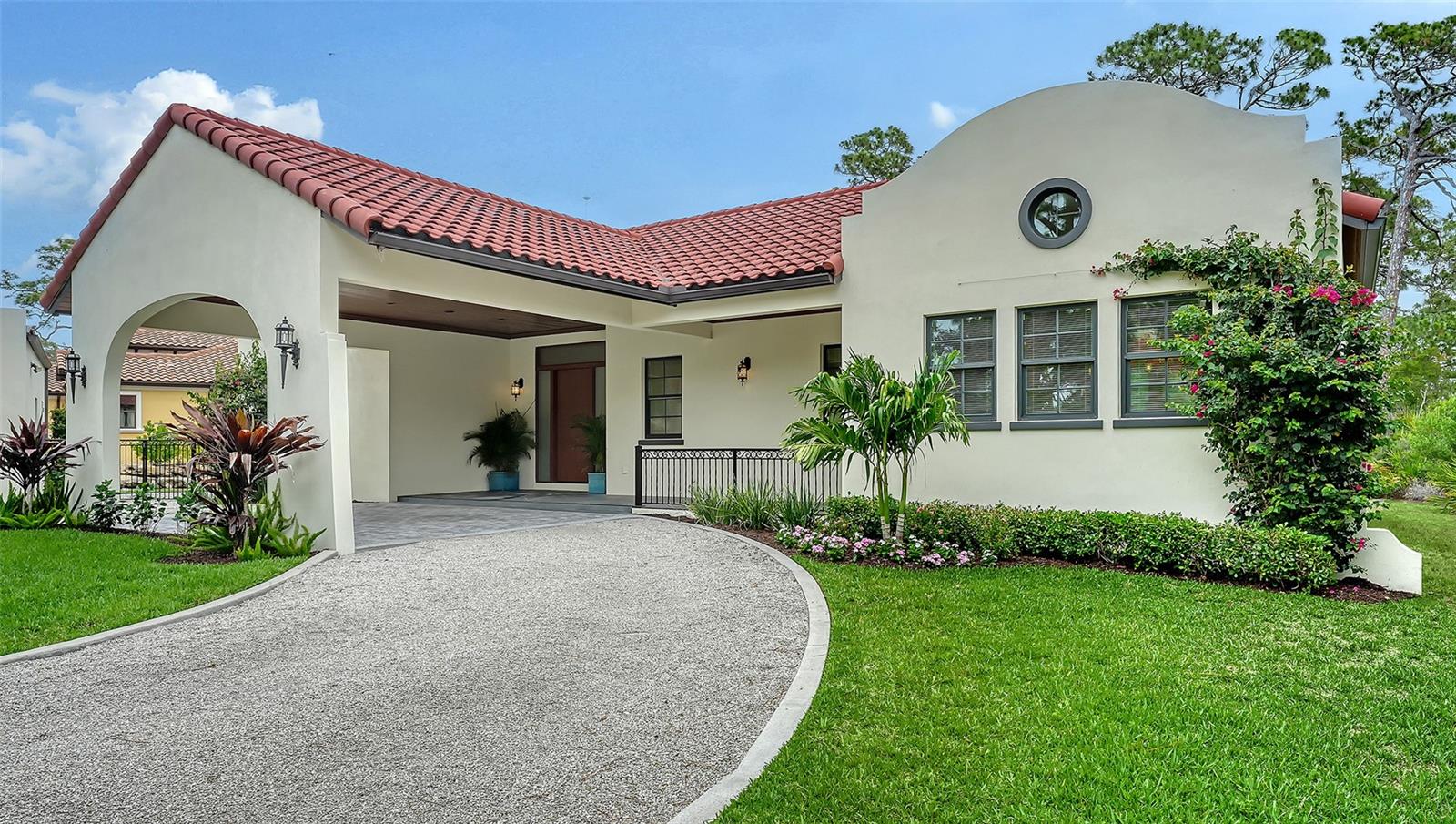 Virtually Staged. A unique offering! This like-new, never lived in Spanish mission style home is a rare find. Move in ready and set on a private .63 acre lot in The Oaks Preserve, the open floor plan includes 3 en suite bedrooms and 3.5 baths. Thoughtfully designed, it welcomes you with a circular driveway, porte cochere, and a detached 2 car garage equipped with an electric vehicle charger. Inside, soaring ceilings, neutral tile and wood flooring, recessed lighting, and an electric fireplace create a warm, refined ambiance. Built to current codes with impact glass and a new roof, the home offers peace of mind and the efficiency of modern construction. The chef’s kitchen, with Bosch stainless appliances, a gas 5 burner cooktop, soft close cabinetry, a center island with wine storage, and stylish tile finishes, has a breakfast bar and opens to the dining room. The luxurious master suite features a vaulted ceiling, spacious walk-in closet, and a spa inspired bath complete with freestanding tub, glass enclosed shower, dual vanities, bidet, and exquisite tilework. A central brick paver courtyard provides a private tropical retreat with ample room to add a pool. Sarasota’s premier golf and country club, The Oaks Club’s unmatched amenities include two championship 18-holf golf courses, 12 tennis courts and 4 pickleball courts, the state-of-the-art WellFit Center, a junior Olympic pool, a celebrated social calendar, and a wide array of dining options and recreational activities. There is currently no waiting list for either Golf or Sports/Social membership