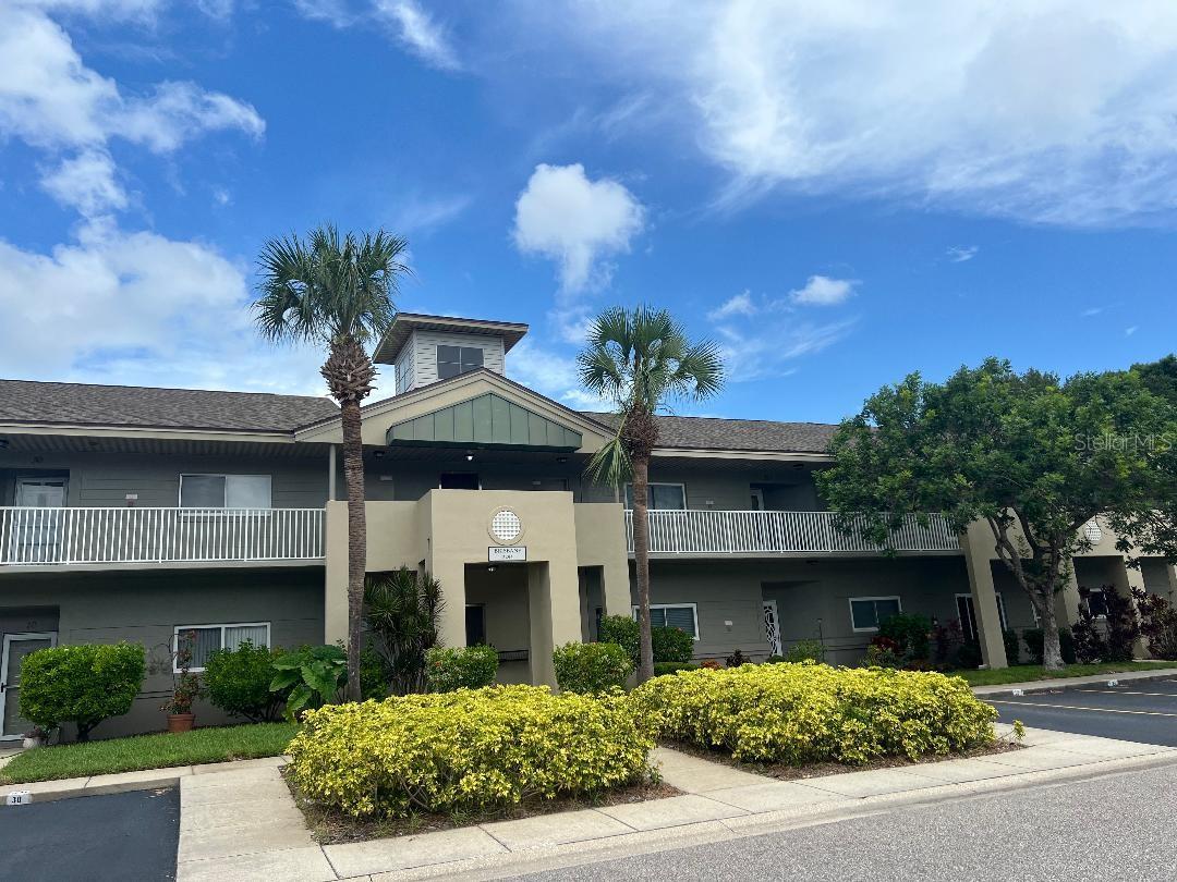 Convenience meets comfort in this spacious, freshly painted 2-bedroom, 2-bathroom condo located in a vibrant 55+ community with amenities for every lifestyle. The home has been thoughtfully updated with luxury vinyl plank flooring, stainless steel appliances, and impact-resistant windows.

Enjoy the convenience of an in-unit laundry with washer and dryer, plus easy access to the HVAC system and water heater. Step through the back door to your large patio, enclosed with elegant wrought iron fencing perfect for relaxing, gardening, or enjoying your morning coffee. An assigned parking space is located just steps from your front door.

This pet-friendly community offers an impressive array of amenities, including clubs, card rooms, billiards, dancing, hobby studios, two golf courses (9 and 18 hole), two heated pools, a fenced dog park, tennis and pickleball courts, a cardio fitness center, and an on-site café. Ideally located near public transportation, beautiful beaches, medical facilities, shopping, dining, and entertainment. Everything you need is within easy reach.

Don't miss this opportunity to enjoy the carefree Florida lifestyle. You will only wish you had moved here sooner!
