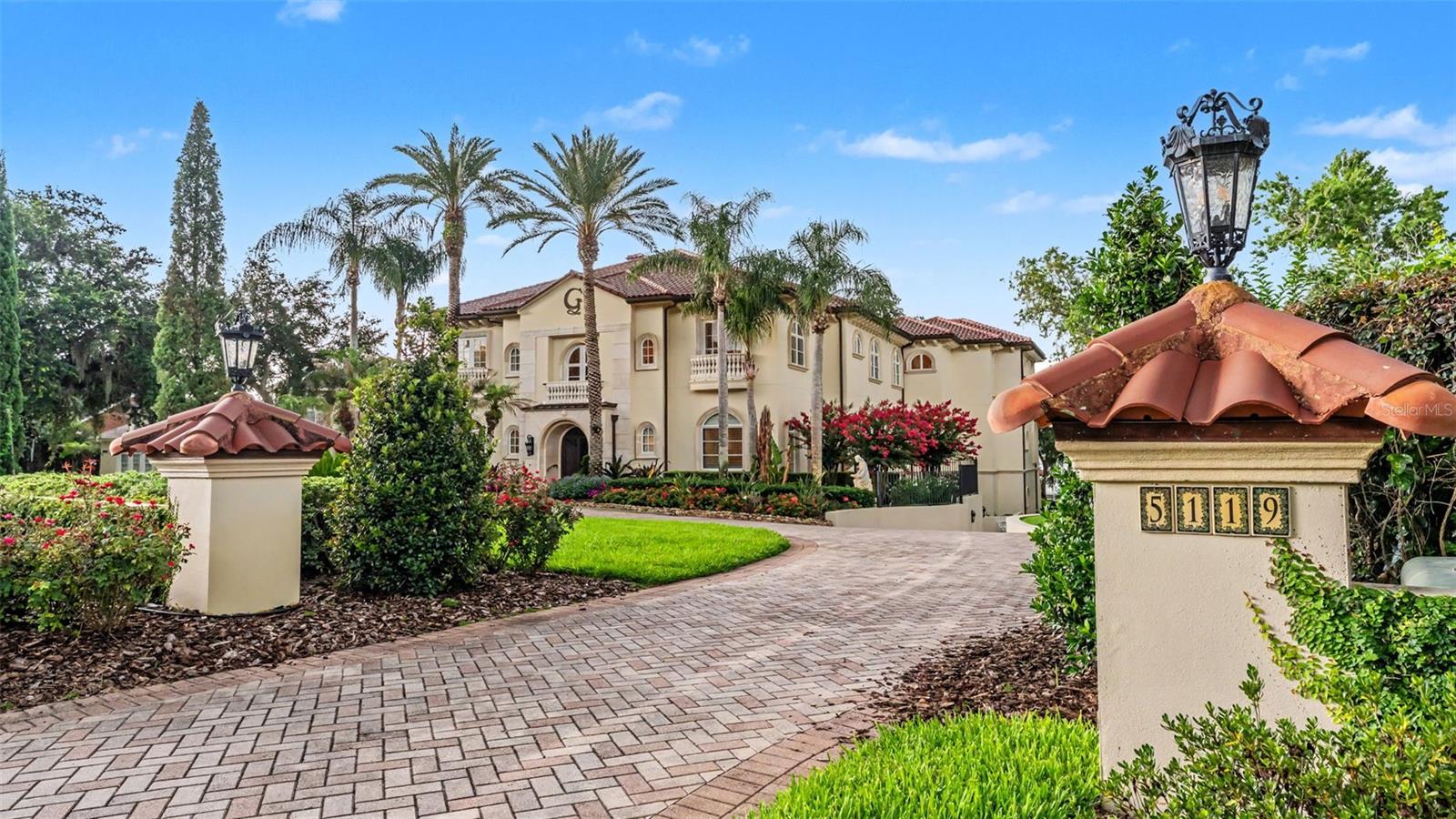 Nestled in the beloved Lake in the Woods community, this waterfront luxury estate stands as a testament to unparalleled elegance and sophistication. Designed with discerning buyers in mind, it offers a stately sanctuary of privacy, tranquility, and ample space. The intentional layout seamlessly blends impressive entertaining areas with flexible spaces, ideal for multi-generational living and diverse needs. The quality of construction, features, and finishes throughout this pristine home is truly unmatched, reflecting meticulous craftsmanship and attention to detail. A private pool with outdoor kitchen, home theater, library, butlers pantry, storage rooms and in-law apartment are just a few of the notable aspects of the floor plan, while smart home features, an elevator, and a whole home generator ensure comfort and functionality for daily living.  Lush landscaping enhances the curb appeal and presentation of the property, while perfectly framing breathtaking sunset views of the lake that stretch across the rolling backyard. For those seeking optimal enjoyment of Scott Lake, the private dock with a screened breakfast room and lifts for a boat and jet skis provides an exclusive access point. This one-of-a-kind opportunity offers an exceptional home experience, complete with incredible views, in a sought-after South Lakeland location.