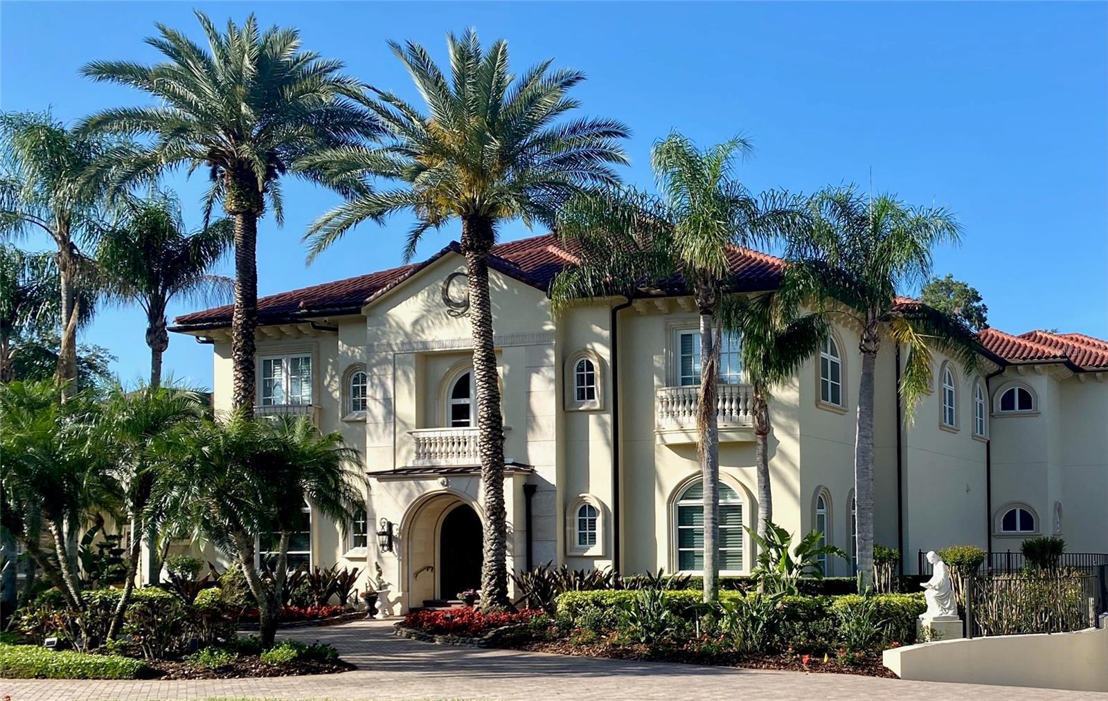 Nestled in the beloved Lake in the Woods community, this waterfront luxury estate stands as a testament to unparalleled elegance and sophistication. Designed with discerning buyers in mind, it offers a stately sanctuary of privacy, tranquility, and ample space. The intentional layout seamlessly blends impressive entertaining areas with flexible spaces, ideal for multi-generational living and diverse needs. The quality of construction, features, and finishes throughout this pristine home is truly unmatched, reflecting meticulous craftsmanship and attention to detail. A private pool with outdoor kitchen, home theater, library, butlers pantry, storage rooms and in-law apartment are just a few of the notable aspects of the floor plan, while smart home features, an elevator, and a whole home generator ensure comfort and functionality for daily living.  Lush landscaping enhances the curb appeal and presentation of the property, while perfectly framing breathtaking sunset views of the lake that stretch across the rolling backyard. For those seeking optimal enjoyment of Scott Lake, the private dock with a screened breakfast room and lifts for a boat and jet skis provides an exclusive access point. This one-of-a-kind opportunity offers an exceptional home experience, complete with incredible views, in a sought-after South Lakeland location.
