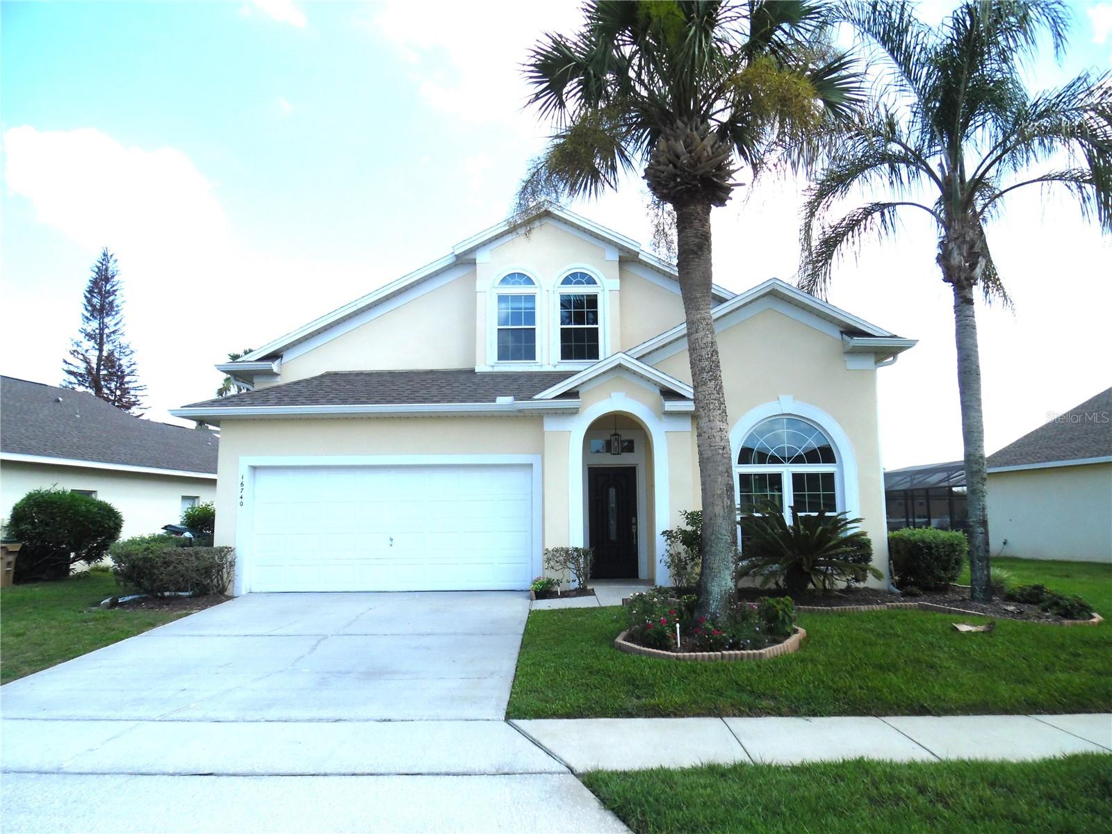 Spacious and beautifully updated, this impressive two-story home offers 3,278 square feet designed with flexibility in mind. Featuring dual primary suites—one conveniently located on the main level and another upstairs—this floor plan is ideal for large families, guests, or multi-generational living.

Recent improvements completed within the last two years include a fully remodeled kitchen with quartz countertops, new flooring throughout, new windows & sliding glass doors, one a/c unit, front door and solar installation, providing modern style and energy efficiency. A new roof was installed in 2022 for added peace of mind.

Step outside and enjoy Florida living at its finest with a heated pool and spa overlooking tranquil water views. Whether entertaining family and friends or simply relaxing, this outdoor space is sure to impress.

Conveniently located just 15 miles from Walt Disney World and close to shopping, dining, medical facilities, and major roadways, you'll have everything Central Florida has to offer right at your fingertips. Don't miss this exceptional opportunity to own a home that offers space, updates, and an unbeatable location.