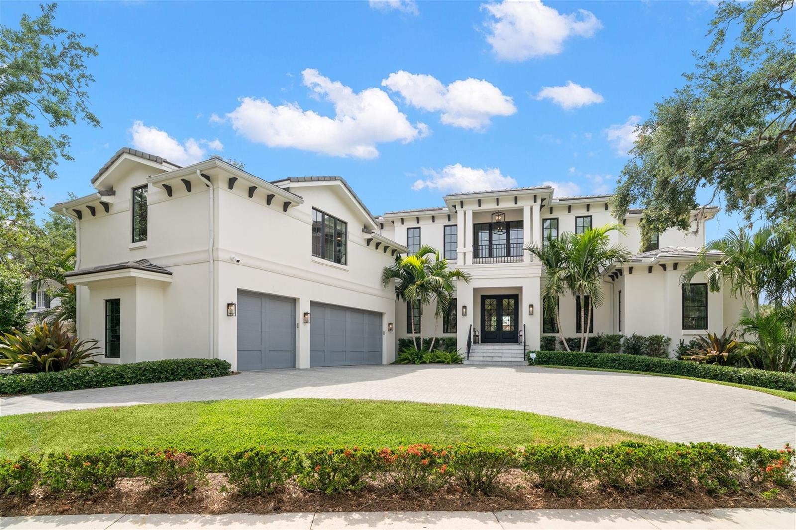 Nestled on one of the most picturesque streets in Beach Park, this custom Bayfair home—completed in 2020—offers timeless elegance, thoughtfully curated upgrades, and exceptional design. Situated on a high-and-dry lot with two-story block construction and a concrete tile roof, the home delivers both peace of mind and refined coastal living. For boating enthusiasts, the property includes a private dock constructed with durable Trex (composite) decking, featuring freshwater access and a 25,000-pound boat lift. The wide canal, dredged for 45’ boats, offers direct access to Old Tampa Bay, allowing you to enjoy the best of Tampa’s waterfront lifestyle with ease and speed. Upon entry, a marble-floored foyer welcomes you inside, opening to an intimate library with floor-to-ceiling built-in bookcases, box beam ceiling and gas fireplace. The spacious living room, lined with French doors, flows seamlessly to the covered patio, creating a natural transition to outdoor living. The formal dining room with custom built-in buffet and serene views out to the expansive backyard and water, connects directly to the heart of the home—an entertainer’s dream kitchen. The chef’s kitchen features a striking 3” quartz island with seating and professional-grade appliances, including a 48” Wolf dual fuel range with grill and griddle, double ovens, Wolf wall hood, Bosch dishwasher, Sharp microwave drawer, SubZero 30" refrigerator and 30" freezer, and Miele built-in coffee system. A full butler’s pantry and oversized walk-in pantry provide additional prep and storage space, along with a U-Line dual zone wine fridge. Downstairs, two bedrooms offer flexibility: one with a walk-in closet and ensuite bath featuring a walk-in shower, and the other currently serving as a light-filled art studio. Additional smart home features on the first floor include a state of the art Kohler Japanese toilet in a beautifully designed half bath, as well as Control4 automation, surround sound, integrated speakers, and automatic shades in the library, dining, and bedroom. Upstairs, the split-bedroom layout continues to impress. A spacious bonus room/game room includes a wet bar, wine fridge, walk-in closet, and dedicated AV closet. Two additional guest suites each offer private baths with marble flooring, elevated vanities, and tub/shower combinations. The owner's retreat is a sanctuary overlooking the water, featuring two walk-in closets, marble flooring, split vanities, marble counters and backsplash, a walk-in shower, soaking tub, and a luxurious Toto Japanese toilet. The upper-level laundry room is outfitted with custom built-ins and a utility sink for convenience. Throughout the home, high-end infrastructure and hand-selected details offer ease and elegance: a whole-home generator, central vacuum system, 4-stop elevator, 3 car garage, three-zone HVAC (2020), two electric tankless water heaters, water softener, Japanese toilets, and Control4 automation. Outside, the resort-style backyard is designed for true Florida living. A covered brick-paved patio and screened lanai with a built-in outdoor kitchen, Marvel beverage unit, and grill make entertaining effortless. The generous saltwater pool and spa are complemented by a separate seating area with a gas fire pit—perfect for evening gatherings. Your Florida Oasis is Now available for private showings.