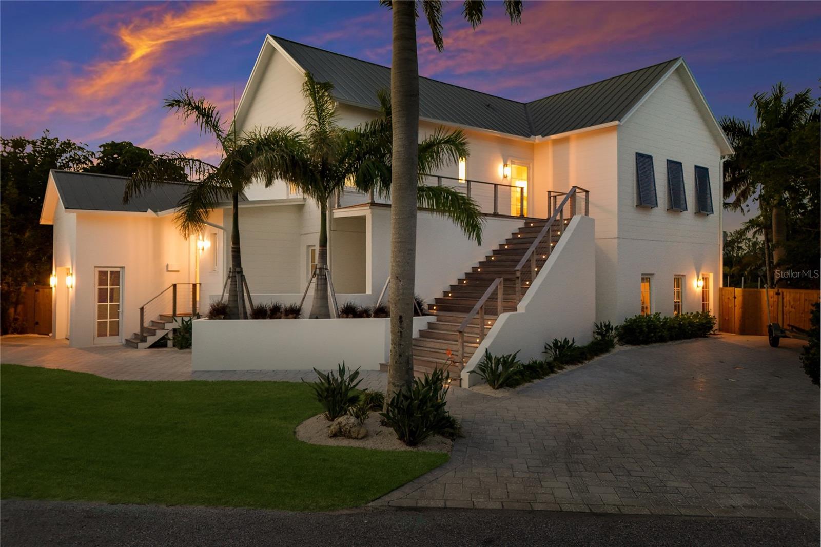Discover coastal elegance at its finest in this stunning 4-bedroom, 4.5-bathroom waterfront home in the heart of Holmes Beach. Designed for both relaxed island living and effortless entertaining, this boater’s dream residence sits directly on the canal with breathtaking views of the bay and spectacular sunrise vistas that greet you each morning.
Step outside to your private waterfront oasis featuring a heated, uniquely shaped triangle pool.  The property offers two robust boat lifts, one 7,500 lb and the other is a 39ft slip with a 20,000 lb making it ideal for everything from a center console to a larger cruising vessel. Multiple balconies and upper deck invite you to unwind with the gentle bay breeze, while lush tropical landscaping provides privacy and a serene, resort-like atmosphere.
Inside, the chef’s kitchen shines with high-end appliances, wine fridge, farm sink, gas burner and thoughtful design, making it a joy for culinary enthusiasts. Hurricane-rated impact windows and sliders throughout offer peace of mind and seamless indoor-outdoor flow. A spacious single car garage with storage for toys and beach gear.
This home perfectly blends luxury and functionality—elevated finishes, generous living spaces, and that enviable waterfront lifestyle Anna Maria Island is known for. Whether you’re watching dolphins cruise by, hosting sunset gatherings, or simply enjoying the privacy of your canal-front sanctuary, every day feels like a vacation.
A rare opportunity to own a true boater’s paradise in one of Florida’s most sought-after beach communities. Schedule your private showing today and experience coastal living at its best.