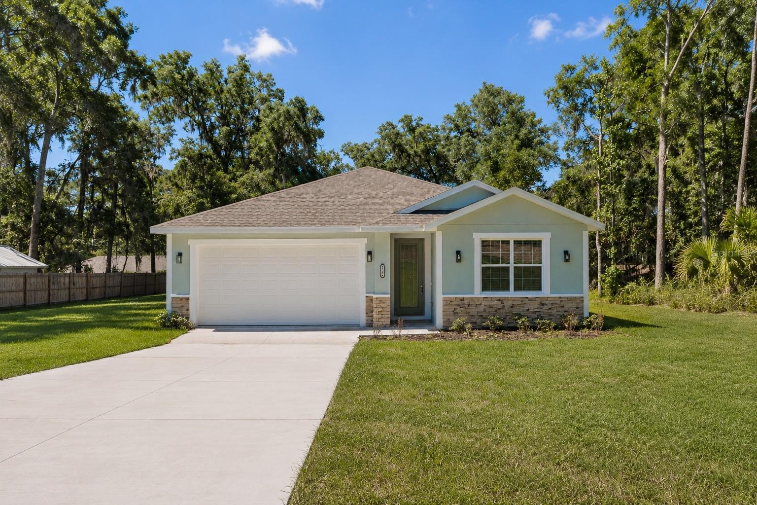 One or more photo(s) has been virtually staged. BEST PRICED 4 BEDROOM HOME IN THE AREA. Brand new and move-in ready, this beautifully designed 4-bedroom, 3-bathroom home features two private bedroom suites, each with its own bathroom, perfect for guests or multigenerational living. Situated on an oversized 0.32-acre lot with no HOA and potential USDA financing for qualified buyers, which may allow eligible buyers to purchase with 0% down payment, this home offers the perfect combination of comfort, functionality, and modern design.

Inside, you’ll find high ceilings with crown molding, ceramic tile throughout the main living areas, and a bright open-concept layout ideal for everyday living and entertaining. The kitchen features granite countertops, backsplash, stainless steel appliances, soft-close cabinetry, ample counter space, and a large island overlooking the living and dining areas. Blinds throughout the home add convenience and privacy from day one.

The home also includes a covered back patio, spacious 2-car garage, and the convenience of well and septic. 1-year builder warranty and 10-year structural warranty for added peace of mind. Conveniently located near Belleview, South Ocala, Lake Weir, The Villages, shopping, dining, outdoor recreation, and I-75.