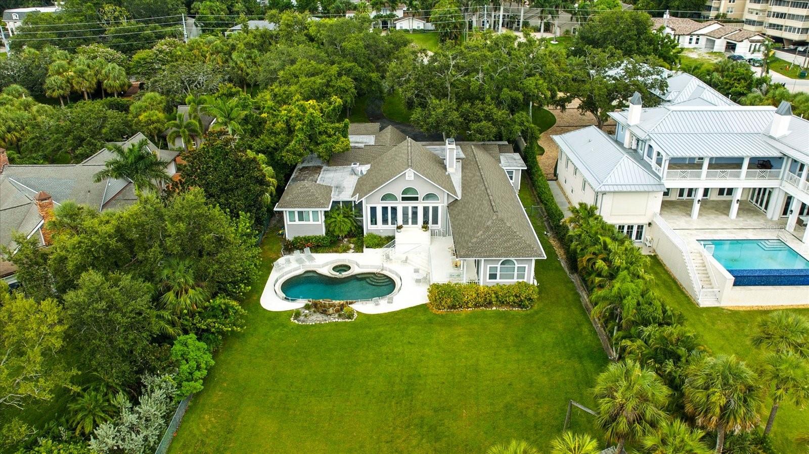 "Sunset Sereno" A Sanctuary by the Sea. Welcome to 228 Bluff View Drive — A waterfront dream in Belleair Bluffs. Nestled in the coveted, private community of Belleair Bluffs, this nearly one-acre estate offers an unparalleled opportunity to embrace luxury waterfront living. Sitting directly on the Intracoastal Waterway and framed by lush, mature landscaping, this stunning property boasts both privacy and breathtaking water views. Located in a non-evacuation area and an X Flood Zone, the home sits a generous 22 feet above sea level, offering peace of mind even during the most powerful storms. Over the years, this property has been untouched by hurricanes, making it a rare and secure investment in the heart of Pinellas County. With palm trees lining the rear of the estate, your daily views are a picturesque mix of serene waters and tropical foliage with the most breathtaking sunsets, creating the perfect backdrop for a tranquil lifestyle. Just minutes from top-rated beaches, surrounded by top-tier dining and shopping where lifestyle, convenience and charm collide. Whether you’re looking to build your dream home or renovate an existing gem, the possibilities for luxury living are endless.