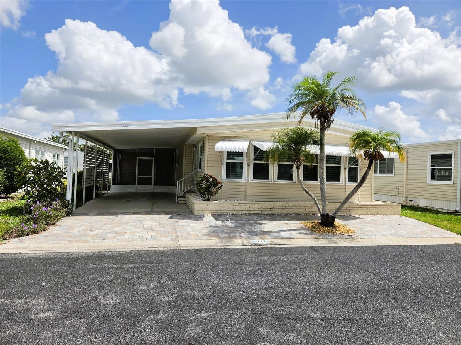 Oakwood Manor — Where Fun and Friendship Happen
Move-In Ready Home in One of Sarasota’s Most Loved 55+ Communities

Experience resort-style living in the heart of Sarasota at Oakwood Manor, a beautifully maintained resident-owned 55+ community spanning 90 scenic acres. Enjoy an exceptional and affordable lifestyle with low HOA fees of just $210/ month and no CDD or master association fees.

Pride of ownership shines throughout this meticulously maintained 1977-built home offering 2 bedrooms, 2 bathrooms, and 1,324 square feet of comfortable living space. Truly move-in ready, the owners have carefully updated and maintained the home so you can simply unpack and enjoy.

Step inside to a spacious, light-filled sunroom surrounded by windows and accented with Plantation shutters — the perfect place to enjoy your morning coffee or unwind with a good book. The large kitchen features ample storage, granite countertops, designer cabinetry, and flows seamlessly into the dining area, creating an ideal layout for everyday living and entertaining.

Kitchen Features:
Granite countertops
Updated kitchen cabinets
Refrigerator only 3 months old
Dishwasher
Stove and microwave
Tile backsplash
Recent Updates Include:
Newer windows
A/C replaced in 2017 (3-ton, 14 SEER)
Plumbing connected to city tap in 2017
Water heater replaced in 2025
Newer gutters
Screened lanai added 2 years ago
Whole-house water filtration system
Upgraded tie-downs
Carport screws replaced
Community Amenities:

Residents enjoy access to an impressive array of amenities, including:

Clubhouse with commercial kitchen and event stage
Fitness center
Library
Heated pool and spacious hot tub
Bocce ball and shuffleboard courts
Putt-putt golf

Pickleball enthusiasts will appreciate being just a short bike ride from the Legacy Trail and its brand-new pickleball courts.

This spotless home is ideally situated just steps from the clubhouse, providing convenient access to community activities and social events.

Conveniently located near downtown Sarasota, Siesta Key Beach, St. Armand's Circle, shopping, Sarasota-Bradenton International Airport, and nearby hospitals, Oakwood Manor offers the perfect blend of comfort, convenience, and active Florida living.

Please note: no pets, motorcycles, or RVs permitted.

Whether you are searching for a seasonal retreat or a full-time residence, this exceptional home is a must-see.