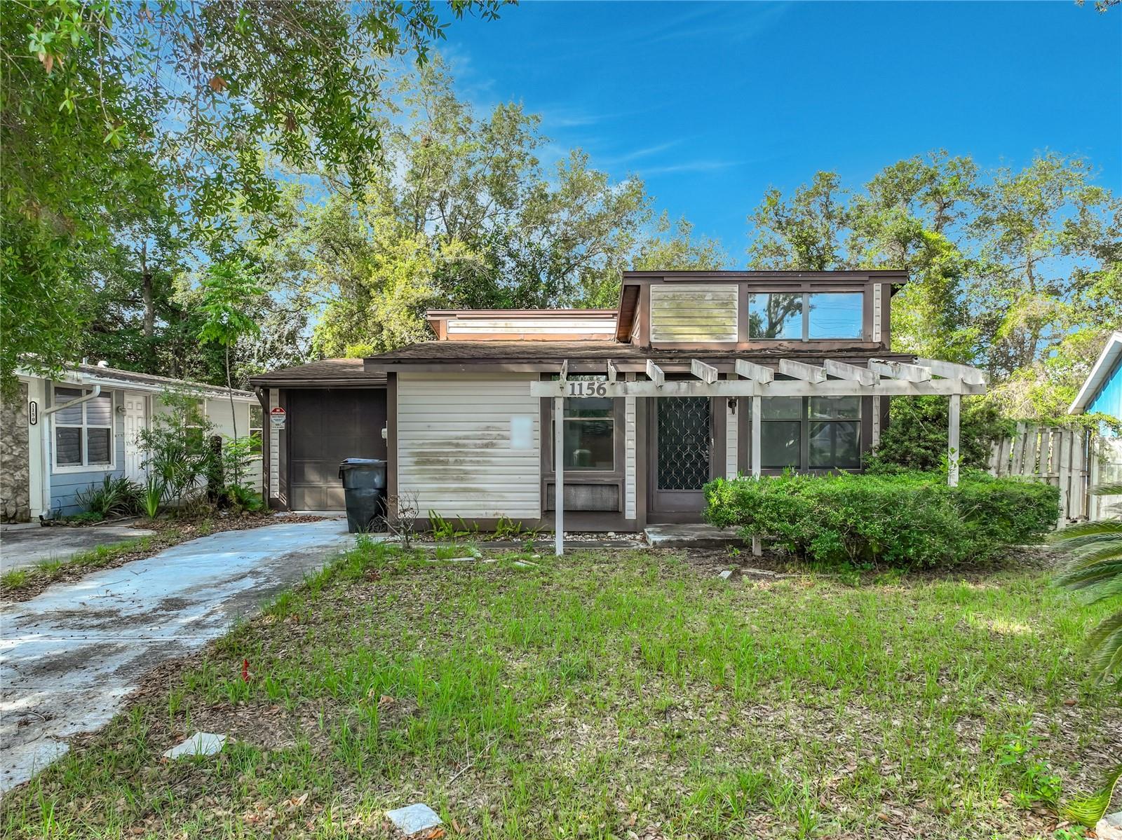 This property presents an outstanding opportunity for investors, renovators, or buyers looking to add their personal touch. Surrounded by mature trees and tucked away on a quiet street, the home offers a private setting with plenty of potential to create something truly special. Inside, you'll find a spacious floor plan highlighted by soaring ceilings, abundant natural light, and flexible living spaces. The kitchen offers generous cabinet and counter space and opens to the main living areas, creating a functional layout for everyday living and entertaining. Spacious bedrooms, an updated bathroom, indoor laundry room, and a large garage/workshop area provide versatility and room to grow. The outdoor space offers a peaceful backdrop with mature landscaping and wooded surroundings. Whether you're envisioning a garden, outdoor entertaining area, or simply a quiet retreat, the property provides a blank canvas for your ideas. Location is a major advantage. Residents enjoy easy access to SR-429, Wekiva Parkway, Downtown Apopka, Mount Dora, and Orlando, making commuting throughout Central Florida simple and convenient. Nearby shopping, dining, medical facilities, parks, golf courses, and recreational amenities further enhance the appeal. Whether you're searching for your next investment property, renovation project, or a home with solid fundamentals and tremendous upside potential, this property offers an exceptional opportunity to create value in a highly desirable location. Bring your vision and unlock the possibilities. Multiple offers received **HIGHEST & BEST OFFER DUE BY MONDAY 7/6 - 11 AM