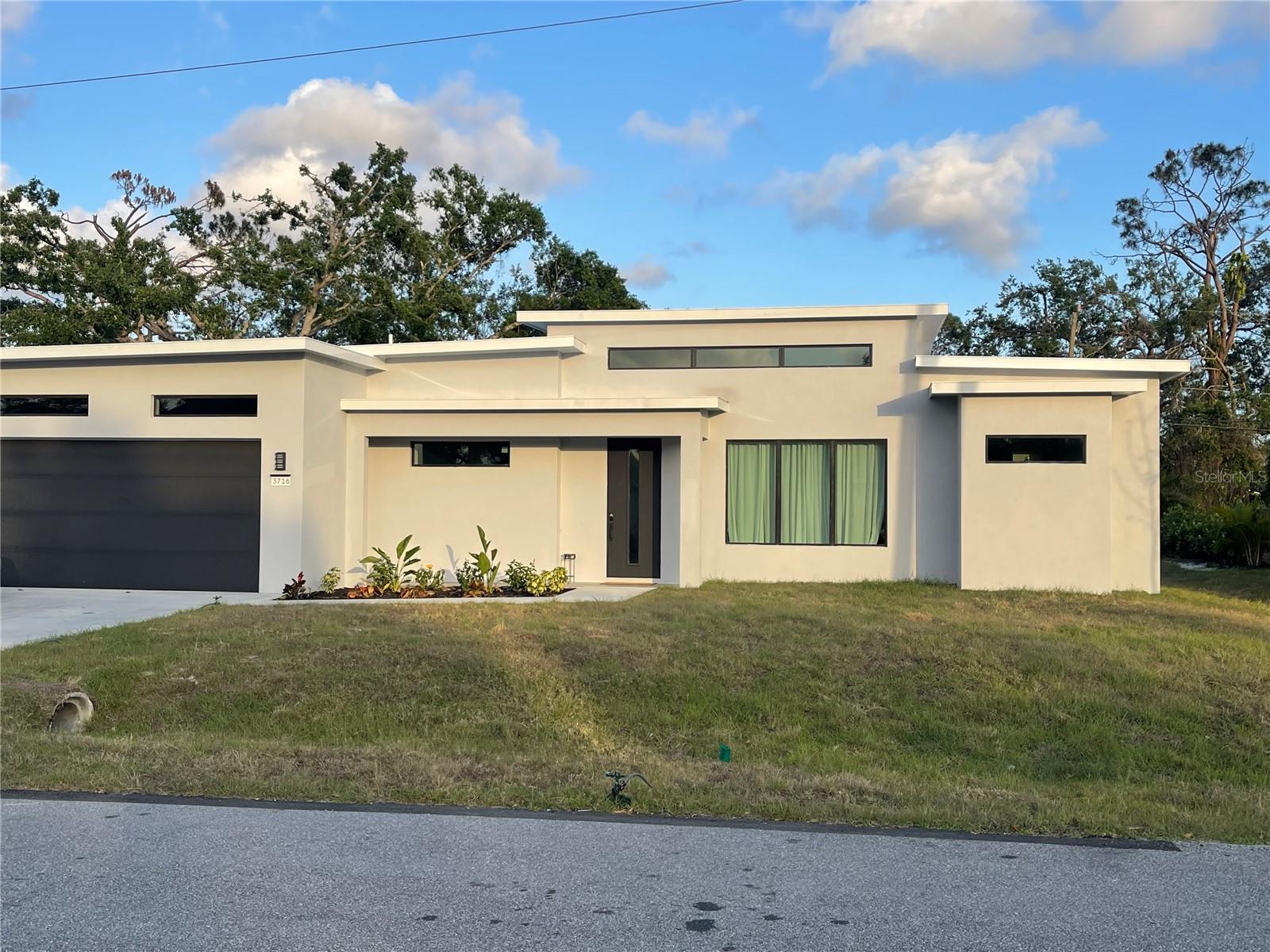 Beautiful, brand new contemporary house. Lots of glass and lots of light. Great central location and quiet area. 3 bedrooms, 2 bathrooms. Split layout. Triple rear lanai. 14' ceilings in the main area and 10' ceilings in all other areas. 8' doors. Laundry machines in place. Hurricane windows and doors. State of the art appliances. City water and city sewer.