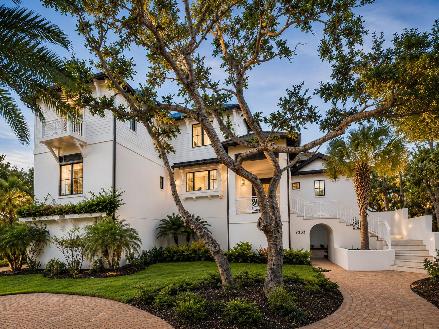 Repositioned to the market - $500,000 Price Adjustment. Exquisite custom estate in one of Siesta Key’s exclusive neighborhoods. Positioned just across from Gulf-front homes in a private enclave on Siesta Key, this exceptional residence offers the ultimate in island luxury. Masterfully built by Perrone Construction and designed by acclaimed architect Rick Oswald, this custom home is a testament to craftsmanship, quality, and elegant coastal living. Sited on a nearly 22,000-square-foot homesite, the home makes a striking first impression with its stately paver driveway and welcoming entry. Inside, wide-plank engineered hardwood floors and rich architectural detailing define the refined interiors, while soaring beam-and-plank ceilings elevate the spacious great room. The heart of the home is the gourmet kitchen, featuring a Thermador six-burner gas range, custom cabinetry, stone countertops, a generous island and breakfast bar, and an adjacent grilling deck for entertaining. The dining room opens seamlessly to the expansive covered lanai, where you’ll enjoy views of the lushly landscaped backyard oasis. A luxurious main-floor primary suite offers a private retreat with exquisite finishes and spa-style comforts, designed for relaxation and ease. Two upper-level guest suites provide privacy for family or visitors and are easily accessed by either the elegant staircase or a private elevator serving all levels. On the main level, a versatile game room doubles as a fourth bedroom with an adjacent half bath, ideal for guests, hobbies or additional living space. Designed with luxury and peace of mind, this home is built with solid concrete-and-steel frame construction and includes a generator, impact-rated doors and windows, lightning protection, Lutron lighting on the main level, tankless water heaters, central vacuum, and a refreshing outdoor shower. The showstopper? One of the largest residential pools on Siesta Key—nearly 44 feet long—designed for swimmers and hydrophiles alike. You'll find multiple places to relax in the sun or shade, surrounded by lush, tropical foliage and an expansive, fenced yard. Car enthusiasts will appreciate the dual two-car twin garages, while the lower-level non-conforming space offers flexibility for an exercise room, pool cabana or additional recreation space. Though built in 2014, this home rivals new construction in design and condition, with a freshly painted exterior and timeless appeal. Just moments from the world-renowned sands of Siesta Beach and Turtle Beach, with easy access to Turtle Beach Marina, island dining, boutique shopping and downtown Sarasota’s vibrant cultural scene, this residence offers a rare opportunity to own a home that blends location, luxury and lifestyle.