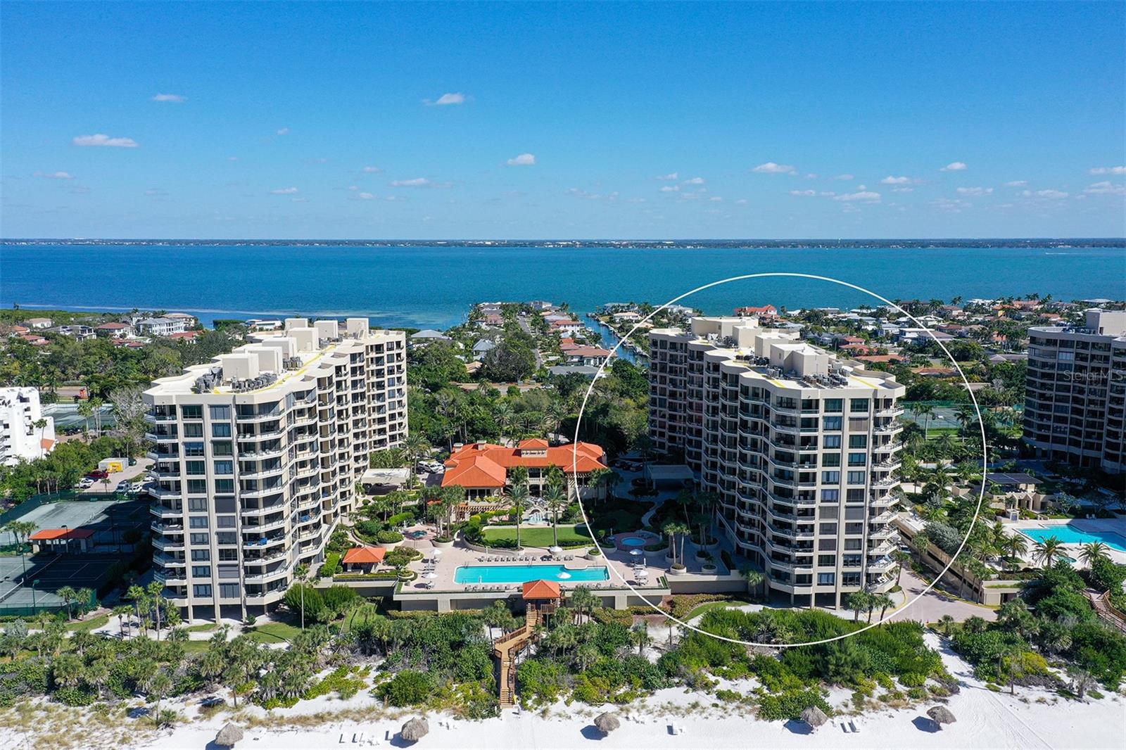 Welcome to The Water Club at Longboat Key, where privacy, spaciousness, and resort-style amenities complement the natural beauty of the setting at the edge of the sparkling waters of the Gulf of Mexico. Residents benefit from a semi-private elevator that opens directly into an impressive foyer, offering sweeping views of Sarasota Bay and the city skyline through floor-to-ceiling windows. This residence is on the north side of the south building, the sunset view side, overlooking the beautiful pool deck amenity of the community. This eighth-floor Brighton residence is highly coveted for its three-bedroom configuration with panoramic vistas of the Gulf, beach, and bay from two expansive terraces. Features include ten-foot ceilings, extensive glass walls, and storm protection shutters , enhancing both comfort and sophistication. The living room is designed to maximize openness and showcase sunsets over the Gulf. The primary suite offers a private terrace, den, walk-in closet, and dual bathrooms. With a split-bedroom plan, privacy is maintained for two generous guest suites, each featuring an en-suite bath. The kitchen is efficiently appointed with significant storage and a breakfast area overlooking the water. The Water Club stands as Longboat Key’s premier gated beachfront community, situated on 16 acres of meticulously landscaped grounds. Amenities include a 17,000-square-foot clubhouse, well-equipped fitness center and spa, heated lap pool and hot tub, four Har-Tru tennis courts, concierge services, and versatile gathering spaces such as a library, billiards room, ballroom, firepit, and grilling area. Additional conveniences include under-building parking, climate-controlled storage, on-site management, and 24-hour security. Ideally located on the south end of Longboat Key, residents enjoy proximity to Longboat Key Club golf facilities, Publix shopping center, exclusive St. Armands Circle, downtown Sarasota’s cultural offerings, and Sarasota International Airport, just 20 minutes away. The Water Club is pet-friendly and impeccably maintained, providing the pinnacle of coastal luxury living.