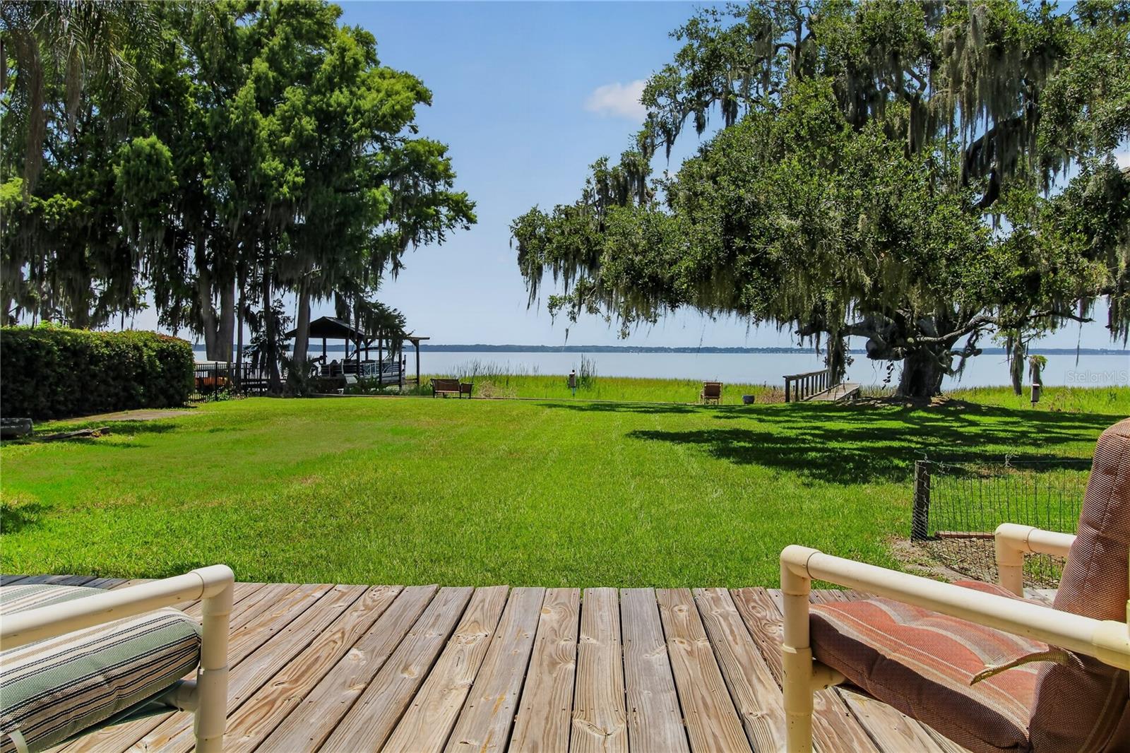 LAKE EUSTIS WATERFRONT OPPORTUNITY! Positioned on 90 feet of direct frontage along Lake Eustis, part of the highly sought-after Harris Chain of Lakes, this 3-bedroom, 2-bath home offers 1,572 square feet of living space and stunning panoramic water views. Enjoy boating, fishing, waterfront dining, and endless days on the water from your own backyard.
Filled with character and timeless charm, the home features a wood-burning fireplace and a classic wood dock extending into the lake, providing the perfect place to take in the scenery and enjoy Florida's waterfront lifestyle. While the home is ready for updating, it offers an incredible opportunity to renovate, personalize, and create the lakefront retreat you've always envisioned.
Located in Tavares, America's Seaplane City, you'll be just minutes from shopping, dining, entertainment, medical facilities, and the vibrant downtown waterfront. Orlando's world-famous attractions, theme parks, and international airport are all within easy reach, making this property ideal as a full-time residence, seasonal getaway, or investment opportunity.
Waterfront properties with this combination of location, views, Chain of Lakes access, and potential are becoming increasingly rare. Don't miss your opportunity to own a piece of Central Florida's premier lakefront lifestyle.