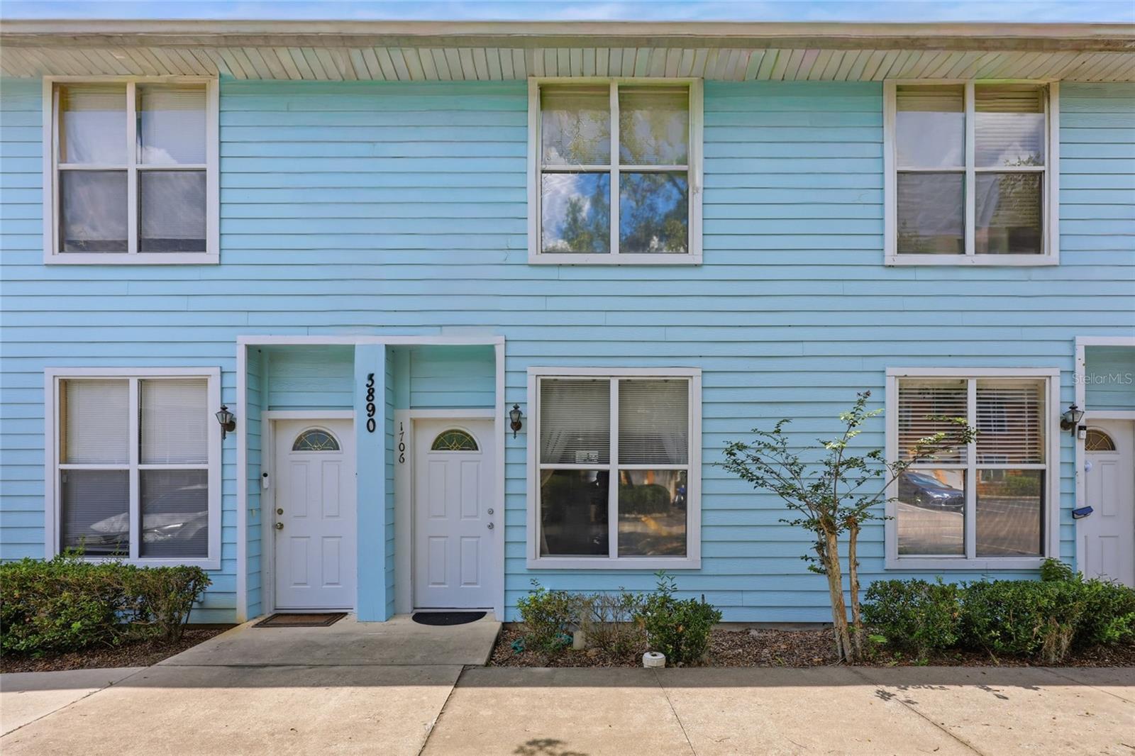 This bright and well-kept Kensington North condo offers comfortable living in a convenient location. Built in 2002, with a new roof in 2022, and featuring 1,176 square feet, this 2-bed, 2.5-bath home provides a functional two-story floor plan with a mix of easy-care tile and carpet throughout. Step into the light and bright living room featuring high ceilings and a spacious yet cozy atmosphere. You’ll appreciate the effortless flow from the living room into the dining area, and then to the kitchen. The dining area and kitchen feature tiled flooring and floor-to-ceiling mirrors that enhance the sense of openness. The kitchen includes stone countertops, a breakfast bar, and a window over the sink for natural light. Appliances include a refrigerator, range, dishwasher, disposal, and new microwave. A laundry area with a washer and dryer is conveniently located downstairs, along with a half bath ideal for guests. An under-stairs closet adds extra storage. Upstairs, both bedrooms feature carpet, private bathrooms, and tub/shower combos. The primary suite includes a walk-in closet. Community amenities include a swimming pool, fitness center, business center, and game room. Kensington North is ideally located off 20th Avenue near shopping, dining, and entertainment at Butler Plaza, Butler North, and Celebration Pointe. Multiple bus routes run just outside the complex, offering easy access to UF and surrounding areas. Schedule your private showing today!