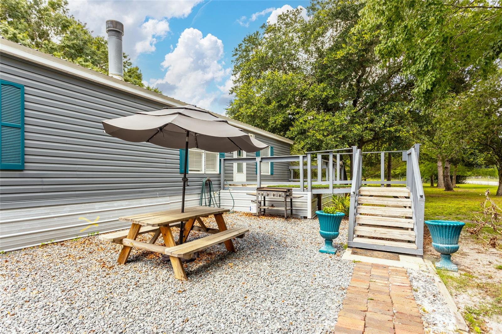 $5,000 SELLER CREDIT OFFERED TO BUYERS!!!! This beautifully updated 3-bedroom, 2-bath manufactured home sits on a fully fenced 0.92-acre corner lot just off of the paved road with an electric gate for added privacy and security. Inside, you'll find the home has been updated with many great features including red oak hardwood floors, a completely remodeled fireplace featuring slate and travertine stonework, and a custom tile shower in the spacious master bathroom. All bedrooms have large walk-in closets, providing ample storage and comfort. The open floor plan offers cozy living spaces, perfect for relaxing or entertaining. Outside, enjoy a chicken coop, multiple storage sheds, and plenty of room for gardening, animals, or hobbies. The well pump and sump pump are both less than a year old, offering peace of mind for new homeowners. This move-in ready property blends rural charm with modern updates—don’t miss your chance to own this unique slice of country living!