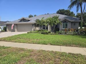 Fantastic opportunity to own a beautiful home in sought after Pipers Meadow. This home boasts natural light through the upgraded hurricane rated sliding doors (4 sets), transom windows over all sliders and most windows! This spacious home offers 4 bedrooms, 2 bathrooms, plus a 3-car garage with brick paver driveway and entry! NEW SHINGLE ROOF COMING SOON! The 3-way split floorplan offers a living room/dining combination, a well-designed kitchen featuring custom maple cabinetry with an abundant amount of storage, granite counters, center island, multiple pantries with pull-out drawers, stainless steel appliances and flat surface range. The kitchen is open to a spacious family room overlooking a sparkling pool! The primary bedroom has a slider to the lanai, large bathroom with a walk-in closet, private commode, soaking tub and double sinks. The 3 bedrooms share a pool bathroom with shower stall and double sink vanity. Enjoy the screened pool and large back yard! Reclaimed water. No Flood Insurance Required. Pipers Meadow is a wonderful community with social activities to include a block party, book club, Jolly Trolley holiday light tour and Bunco! Currently zoned for Palm Harbor University High School and Palm Harbor Middle. Best location! Minutes to the top beaches in Florida and the Pinellas Trail. Close to retail stores and medical facilities. This home is a MUST SEE!