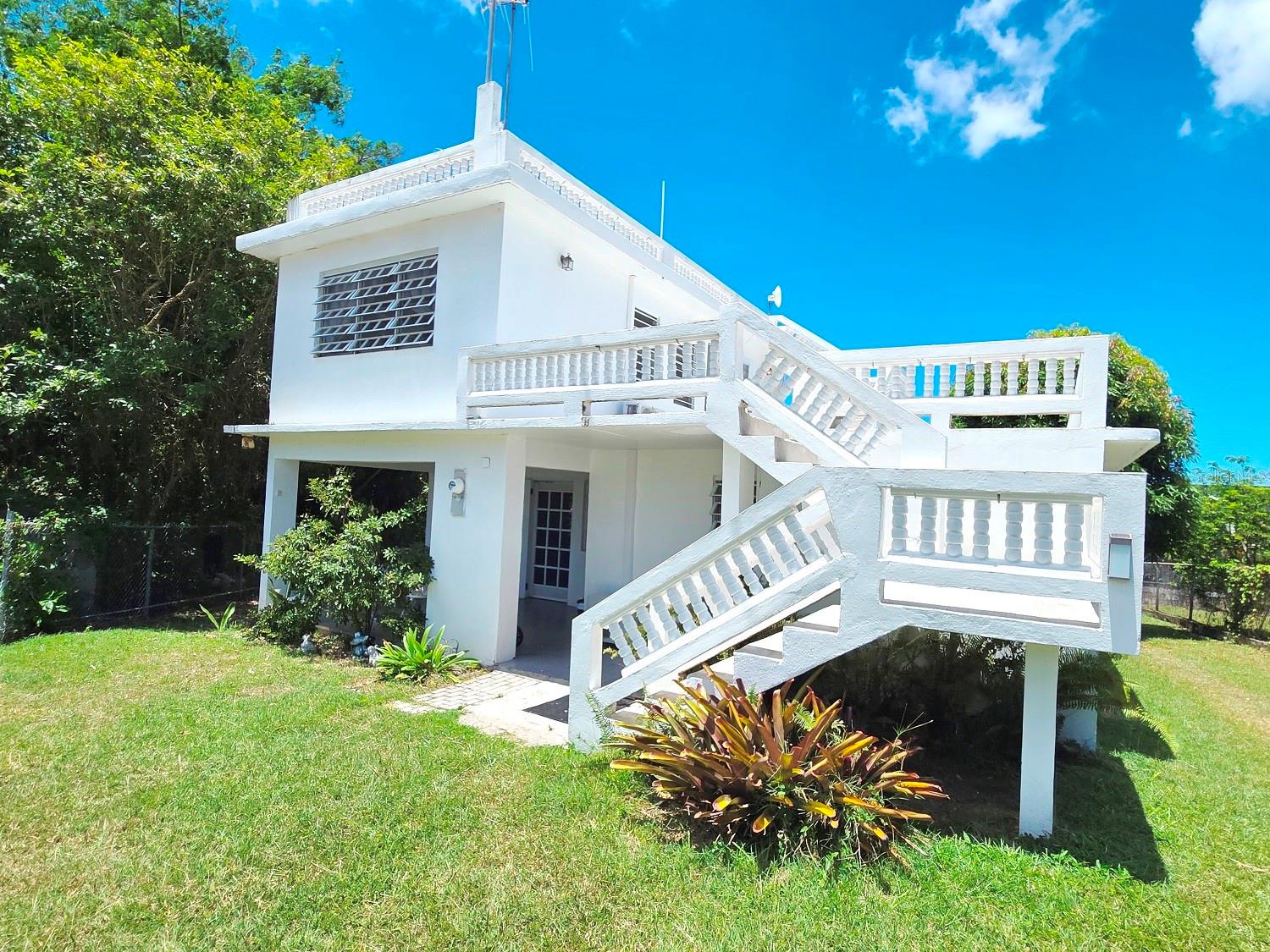 REMARKABLE FIND IN BARRIO FLORIDA!  Impeccably maintained two story home on a 654.98 square meter lot in quiet Barrio Florida.  Two air-conditioned bedrooms and a bath downstairs, with a dining room living room combo, a kitchen, and an inviting front porch.  An air-conditioned bedroom one bath accessory unit is located on the second floor.  It has a separate entrance, a kitchen, living room and ample balcony, and could be used as a rental, office or studio, or even a mother-in-law’s suite.  On the roof above it is a spacious deck with a glimpse of the ocean.  Well-constructed stairs and railings throughout.  Perfectly sized fenced yard with ample room to park, garden, or even a pool.  Mature landscaping with mangos, guava, papaya, soursop, beach grape, pineapple, cilantro and assorted flowers.  Furnishings negotiable.  Titled.