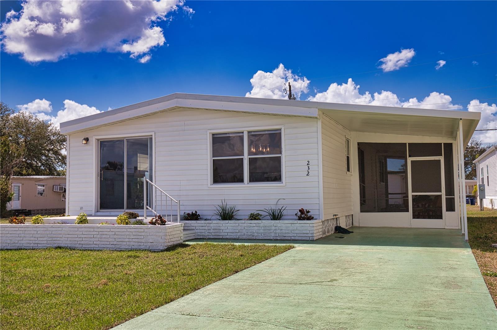 LEASED LOT $99 FOR THE ENTIRE YEAR!!! Space abounds in this partially furnished 2-bedroom, 2-bath home that offers the perfect blend of affordability, comfort, and Florida sunshine in one of the area’s most desirable WATERFRONT communities with direct GULF ACCESS via the Myakka River. Nicely updated with new vinyl flooring, freshly painted throughout, new water heater, plenty of storage, and both baths have been completely updated. The vapor barrier and insulation has been inspected, replaced and updated as needed to include the tiedowns.  The screened lanai feels instantly welcoming, and adds extra space for casual dining, or relaxing with friends.  Outside, sit in the sun on the front patio and enjoy your morning coffee or afternoon tea. The extra storage plus washer and dryer in the shed. Harbor Cove’s lifestyle is truly unmatched. The two-story clubhouse overlooking the 90-slip marina is the heart of the community, hosting dances, trivia nights, entertainment shows, card games, billiards, picnics, and more. The occasional food truck and vegetable market visits are a treat and very convenient. Residents enjoy two swimming pools, a hot tub, fitness room, tennis and pickleball, bocce, shuffleboard, and even an optional woodworking shop. With boat slips available for a minor fee,  you can cruise miles of scenic waterways and enjoy some truly great fishing along the way. With beaches, golf, restaurants, Costco, retail shops, and quality medical services all nearby, this is the perfect place to enjoy an active, social, and relaxed Florida lifestyle.
