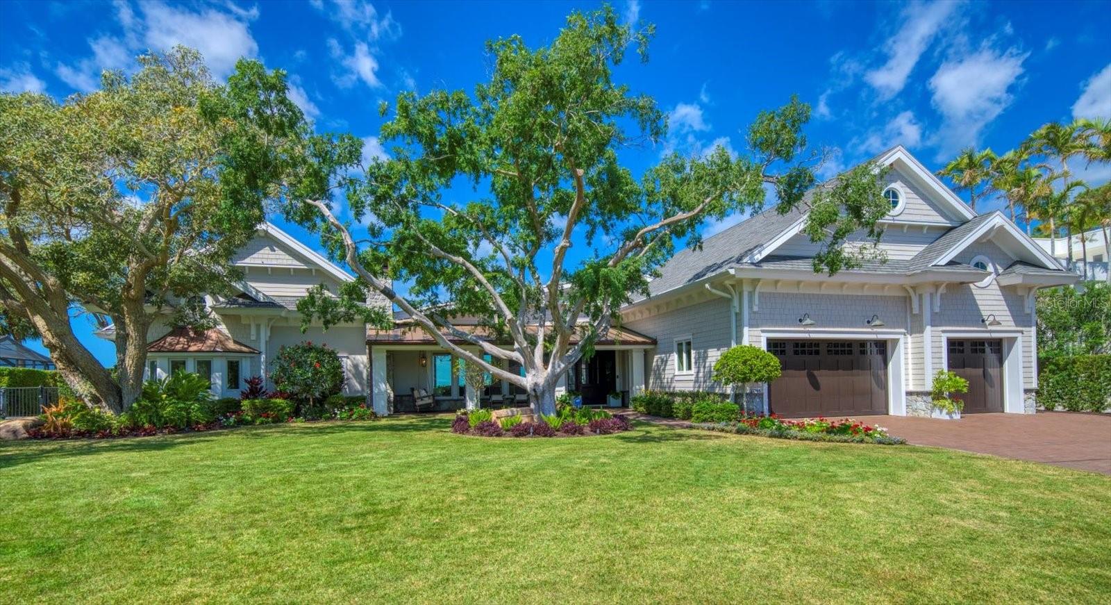This location is unmatched….a double lot on open, boating water in Pinellas County’s most charming coastal town!  The home is a bespoke total renovation in 2018, guided by the expert design of Oliveri Architects and executed with exceptional quality and materials by Brandon Construction.  Swings and rocking chairs greet you on a gracious front porch.  The “wow” comes when you enter into the home’s tremendous great room with its big water views.  The incredibly spacious living area accommodates large gatherings, but is complimented by several more intimate seating areas.  The kitchen is the perfect marriage of beauty and function.  Cooking and entertaining is made easy with the Wolf 48” gas range, double ovens, warming drawer and thoughtful features like the Scotsman ice maker and built-in Miele specialty coffee maker .  The custom Amore stainless and brass range hood is a work of art, as is the mammoth island, countertops and back splash of breathtaking Taj Mahal quartzite.   A gas fireplace in the dining/kitchen area adds both warmth and character.  The home has 3 luxurious bedroom, all with ensuite bathrooms. The cabana room with its grand water views, built-in murphy bed and private bathroom could easily serve as a fourth bedroom suite with the addition of a closet.  The outdoor space of this home is exceptional!  The terrace, pool and spa beckons you, offering peaceful spots to relax both in and out of the sun.  Enjoy quiet moments by the built-in firepit or spread out on the vast lawn, large enough for a lively volleyball game!  The dock was constructed in 2018 and offers a remote controlled, 25,000 lb cradle lift, as well as an additional 50 ft. slip.  This is the waterfront home you’ve been patiently waiting for!  The coveted brick streets of Dunedin are located just minutes from white sandy beaches, the Pinellas bike trail and a vibrant downtown you can access by golf cart if you wish!  Do not hesitate on this one!  A full list of renovation details is available on request.