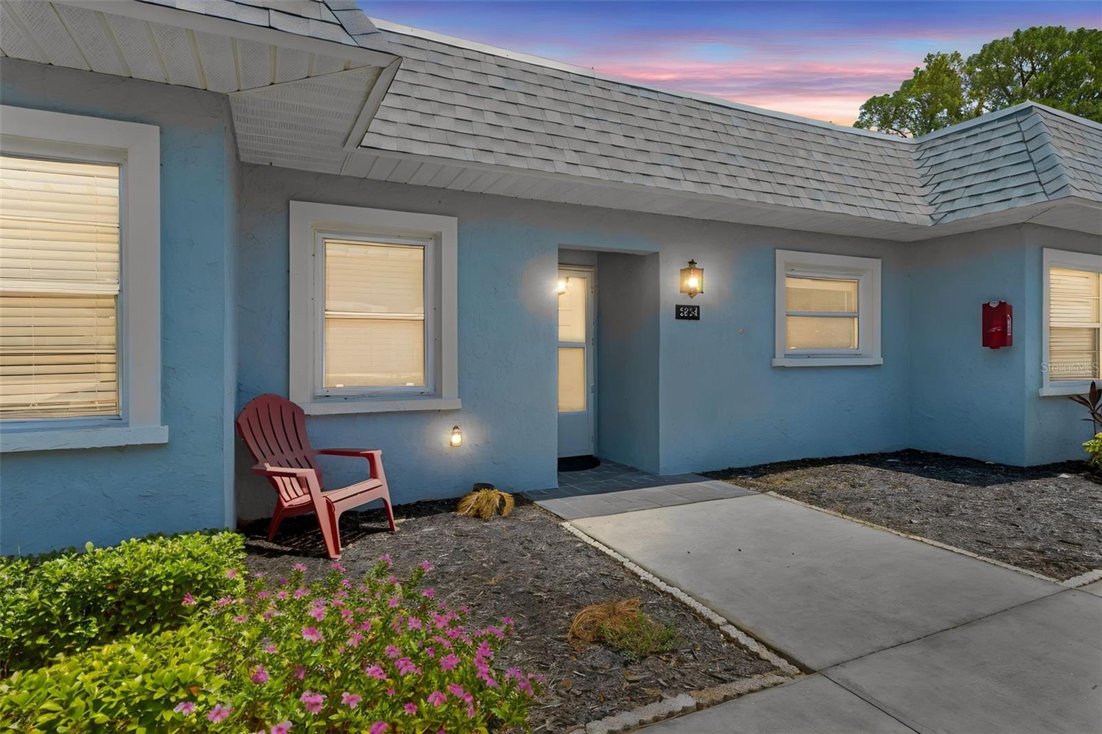 Beautifully updated 2-bedroom, 1-bath condo located inside the gated Seven Springs Golf & Country Club community. This move-in ready unit features modern monochrome finishes, ceramic tile flooring throughout, solid wood cabinetry, solid surface countertops, and an open living/dining layout designed for comfortable everyday living.

Enjoy the private enclosed lanai plus an additional open patio space perfect for relaxing outdoors. The unit also includes inside laundry, assigned covered parking, and extra storage.

The monthly association fee includes guard-gated security, exterior maintenance, grounds maintenance, water, sewer, trash, cable, and internet, making for low-maintenance Florida living.

Residents have access to community pools, tennis courts, pickleball, planned social activities, and optional golf amenities including a pro shop and cart rentals. Conveniently located near shopping, restaurants, Trinity Medical Center, beaches, and Tampa International Airport.

Schedule your private showing today!