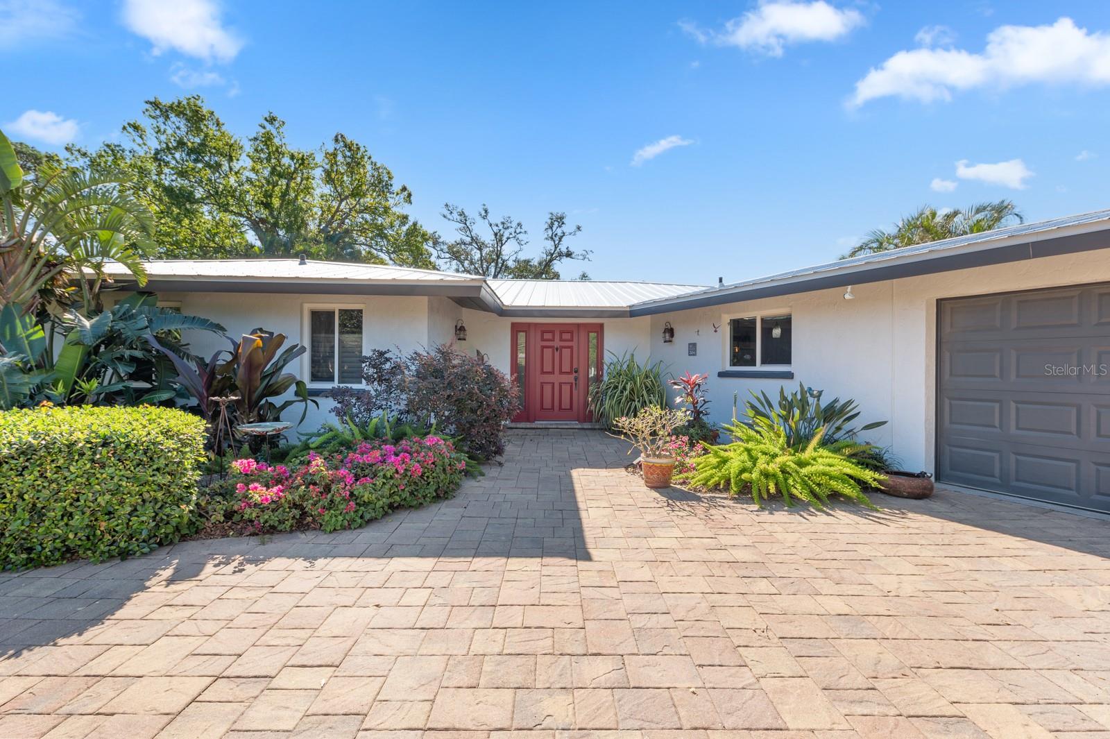 This residence boasts a perfect blend of comfort, style, and functionality, offering an ideal retreat for those seeking the quintessential Florida lifestyle.  This three-bedroom plus den/three bath home has designer touches with an open floor plan.  Internally, the space sings with an updated kitchen featuring ample counter space, a breakfast bar and perfectly complemented by stainless steel appliances. Every detail has been meticulously curated for your comfort; new metal roof (2020), new hot water heater (2023), detached pool house/outside shower (2019), IMPACT PGT windows and doors THROUGHOUT, and solar pool heater (2021).  The pool and back yard provide a picture-perfect view overlooking the lush tropical landscaping which makes it the perfect space for entertaining.  Despite its secluded feel, this oasis remains conveniently close to UTC, downtown Sarasota, the new Mote Marine, and SRQ airport.  On daily walks, enjoy the most expansive view of the bay, overlooking Longboat Key.