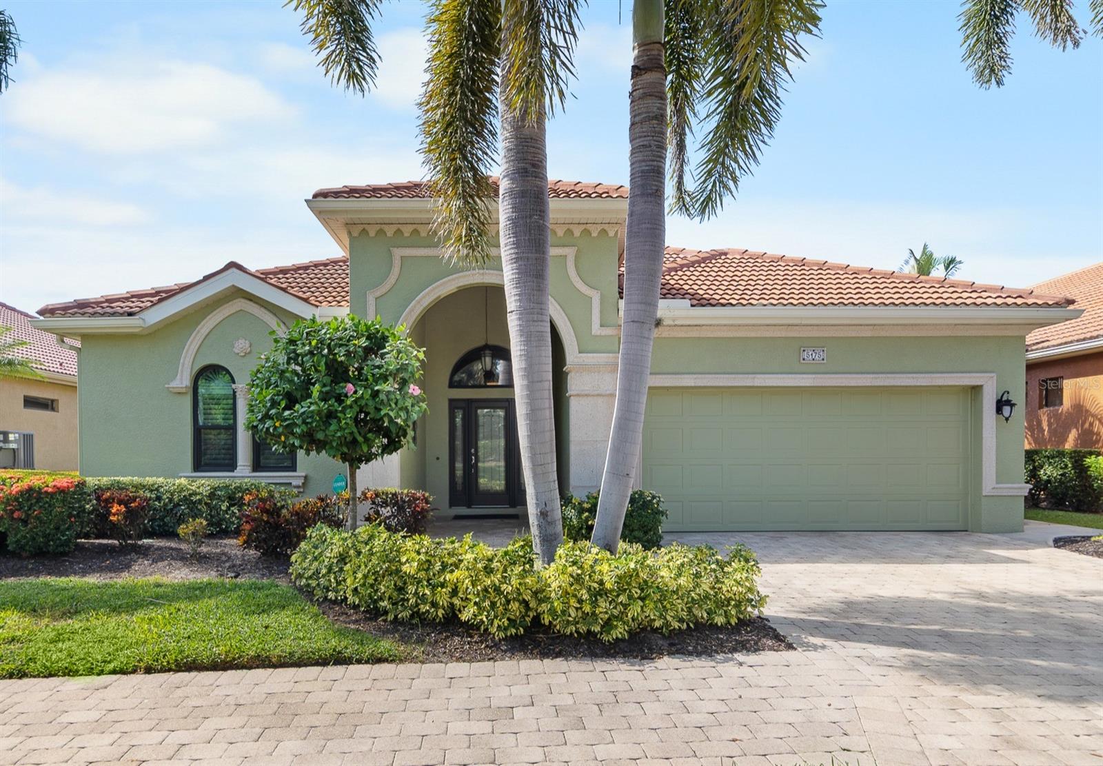 NEW TILE ROOF to be installed prior to closing! Welcome to the highly desirable GATED COMMUNITY of SILVER OAK.  An impeccable community featuring MAINTENANCE FREE LIVING developed by the QUALITY BUILDER- GIBRALTAR. Why settle for unknown quality? Gibraltar is considered one of the best in Southwest Florida when this community was developed. This home was a seasonal residence, like new interior. Enjoy beautiful lakefront views from the minute you enter the home. Notice the custom features including IMPACT WINDOWS, volume trayed ceilings, wood floors, and custom mill work. The current homeowner has lovingly updated every room in the house including the chef’s kitchen with beautiful granite counters, glass tile backsplash and stainless-steel appliances. The breakfast area features lake views where you can enjoy your morning coffee watching the heron fish for breakfast outside your door. The star of the show is the view of the lake through the large 27-foot screened lanai where you can enjoy your favorite beverage as the Florida sunset paints the clouds. A separate formal dining area has plenty of room for family or neighbors to have an elegant meal or simply play cards. A built-in wine bar can be used as butler’s pantry or center for entertaining. The primary bedroom provides more lake views, custom millwork, and an upgraded ensuite spa-like bath where a dip in the garden tub can wash your cares away. Two closets provide plenty of storage. The split bedroom has lots of space for guests. The 3rd bedroom/office has double doors to easily become additional living/entertainment area. The garage is air conditioned and has a spotless polyaspartic (epoxy) floor. Silver Oak is located in the highly popular Palmer Ranch. The Legacy Bike Trail is adjacent to the community and allows you to ride, walk or jog to downtown Sarasota or Caspersen Beach in Venice. Plans are to ultimately link this to trails along the entire west coast of Florida. The home is few minutes from Costco, Target, Lowes and a plethora of other shopping.