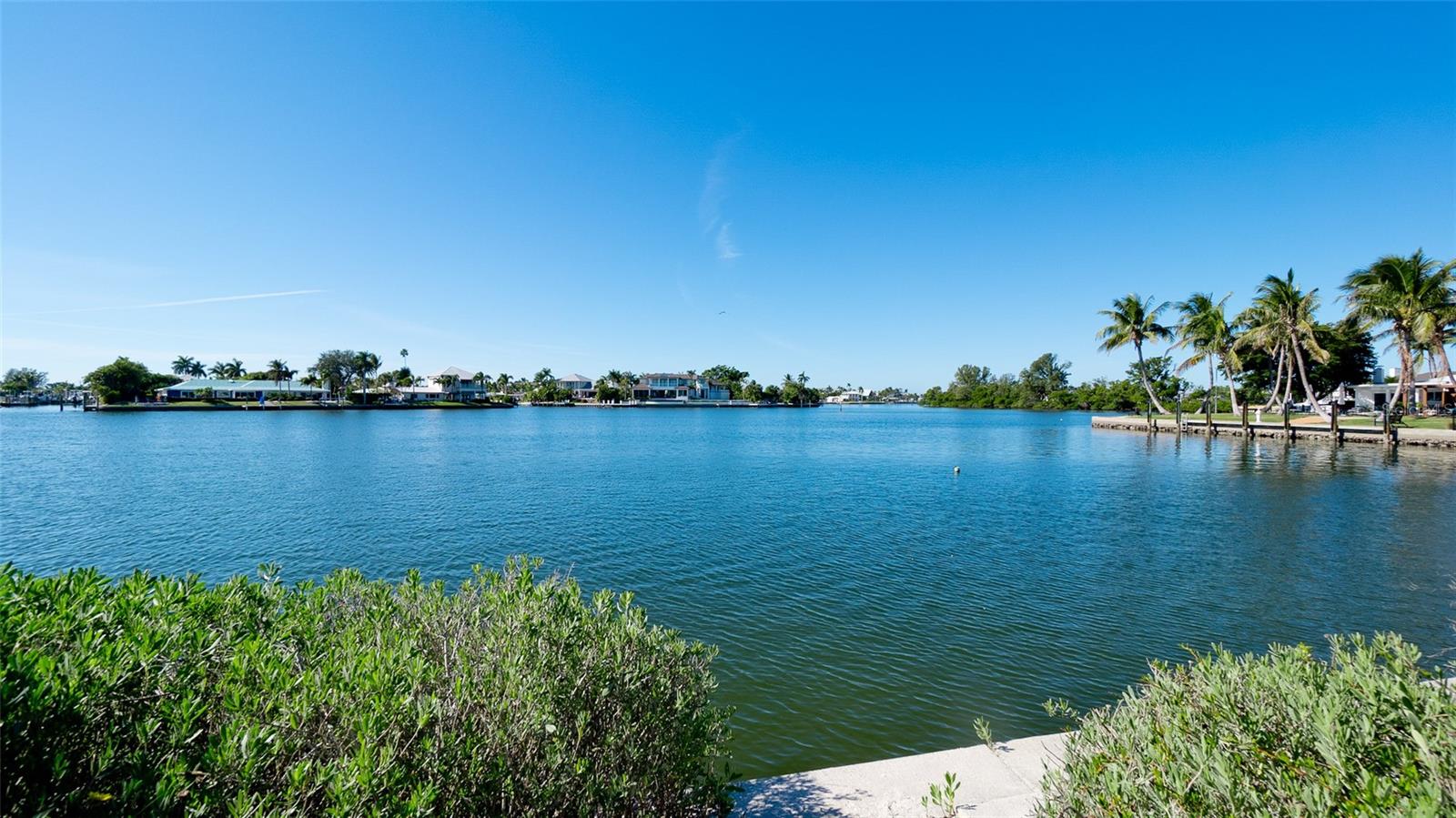 Welcome to this sweet cottage located on a cul-de-sac on Anna Maria Island. Situated on a large waterfront lot with spectacular views on Bimini Bay. Renovate this home to your taste and needs or remove it and build your dream home. The house has a main bedroom suite with private bath, a guest room with bath as well as a living room, dining room, family room, kitchen and a large glassed in lanai overlooking the bay. There is also a two car garage and laundry area. The 14,680 sq ft lot has 234 ft of water with expansive views. The lot wraps around the canal for calm protected waters for your boat or dock.   It is situated on an elevated lot with deep water access to the Intracoastal Waterway and Anna Maria Sound. There was no damage to the house during the 2024 storms. The sea wall has been recently repaired.  There is plenty of room for a pool. Key Royale has a private Gulf Club and is a short ride to top rated restaurants, boutique shops and the famous beaches on Anna Maria Island. If you are wanting a beach get away or to build your dream estate, this is the place for you. View the best sunsets right from your back yard on one of the most desirable lots in Key Royale. The value is based on the land and location. See land listing at MLS A4675581.
