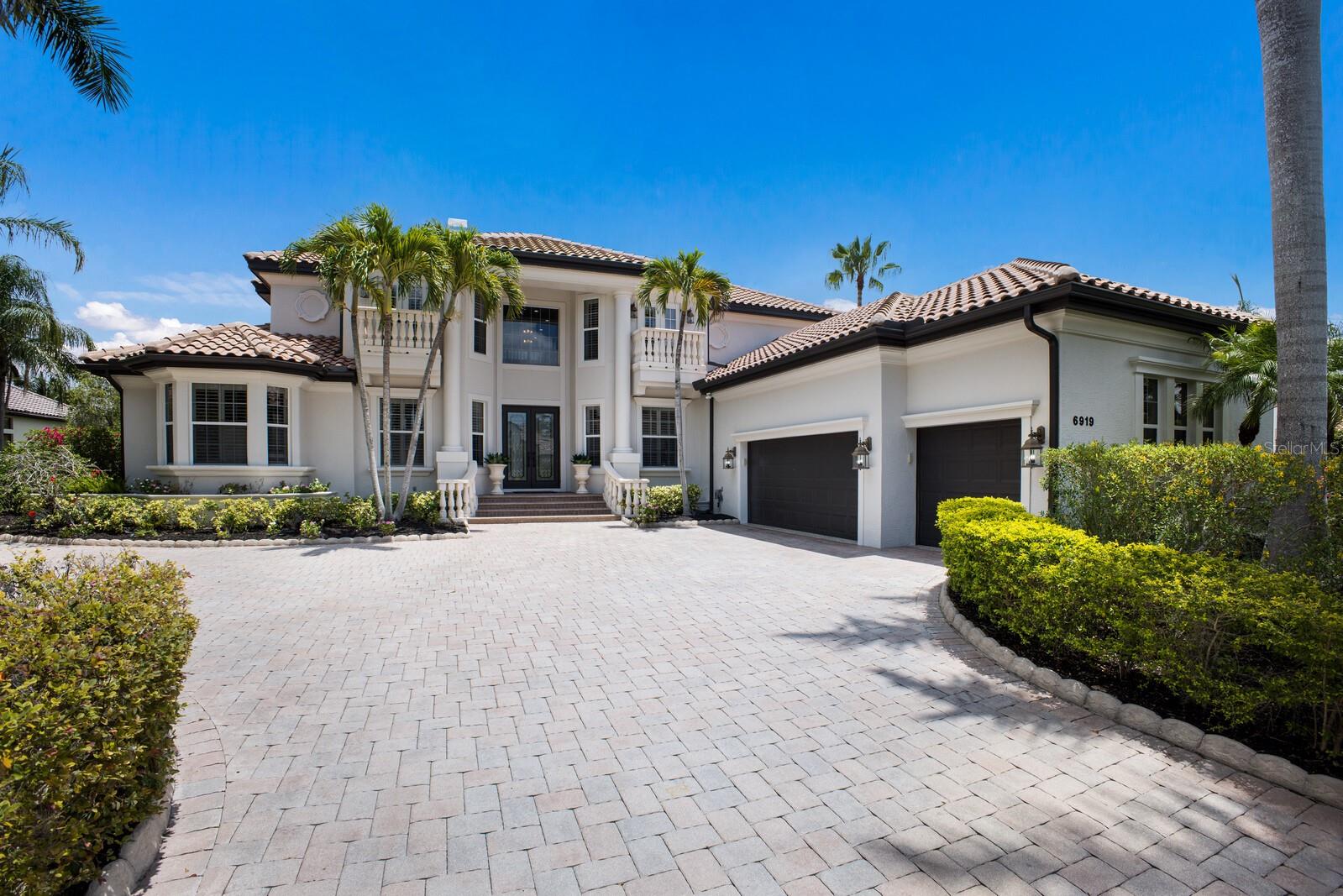 NEW PRICE AND READY FOR QUICK MOVE IN! Set on a premium golf course lot boasting MORE THAN a half acre, behind the gates of the highly desirable Lakewood Ranch Country Club, this 4,737 sq ft Arthur Rutenberg-built estate WITH FENCED YARD offers a BRAND NEW ROOF and showcases refined luxury and architectural grandeur. With 4 spacious bedrooms, 4 full bathrooms, and a half bath, this two-story residence offers both elegant formal spaces and inviting everyday comfort. From the moment you enter, you’re greeted by a dramatic two-story living room with gas fireplace and two-story great room with soaring ceilings, custom millwork, and expansive windows that capture serene golf course views. Natural light pours into every corner, creating an open and airy ambiance throughout. The expansive lanai has two large covered space and highlights an enormous pool, perfect for swimming laps or just splasing around enjoying a pool party! The gourmet kitchen is a chef’s dream—well-appointed with premium cabinetry, a center island, granite countertops, and top-of-the-line appliances—flowing seamlessly into a generous casual dining space and inviting great room. An elegant formal dining area and a private office/study with built in partners desk are conveniently located on the fist floor along with the expansive primary suite.  There is a generous size bonus room tucked away off the great room with french doors to the covered lanai and perfect for an exercise room, playroon or game roon with a bar area!  Retreat to the luxurious owner’s suite, which boasts dual walk-in closets, a spa-inspired bath with massive soaking tub, and direct access to the lanai. Upstairs, each additional bedroom offers ensuite convenience and ample closet space, ideal for family or guests. Guest rooms #1 & #2 offer juliet balcony's and Guest #3 offers a private sun deck perfect for morning coffee, sunset cocktails or yoga area overlooking the panoramic golf course vistas.  Don't miss the second floor bonus room that can easily be converted to a fifth bedroom or teen lounge! Furry friends can run free in the backyard with puppy fencing! Every inch of this home reflects the timeless craftsmanship Arthur Rutenberg is known for, wrapped in the serenity of one of Southwest Florida’s most sought-after golf communities. Whether you’re hosting lavish events or seeking quiet luxury, 6919 Westchester Circle is the perfect blend of distinction, comfort, and resort-style living. Lakewood Ranch Country Club is an optional country club membership offering four golf courses, three clubhouses, twenty lighted tennis courts, pickleball courts, athletic center, olympic pool with lap lanes, volleyball court, basketball court, playground and more!  Enjoy top rated public schools, expansive new restaurant choices and shopping options just minutes away.  Hurry in and don't wait to tour this majestic residence.