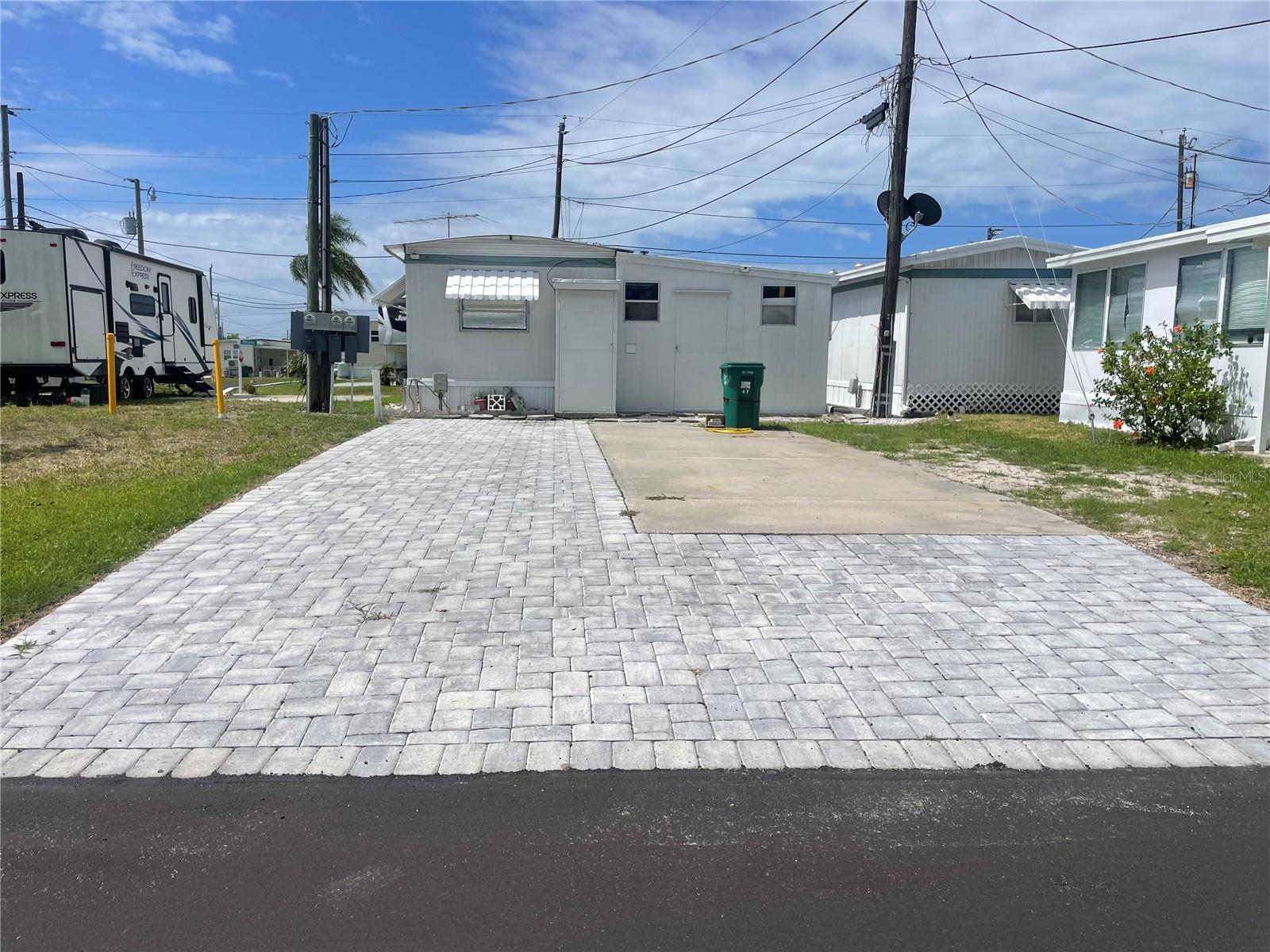 Welcome to lovely Jet Park! Jet Park is a great low key, active 55+ community located in a great central location of Palmetto. Close to shopping, restaurants, groceries and many major thoroughfares.  Low monthly fees of only $195 a month.  Bring your RV, trailer, 5th wheel to Florida whenever you want! Sites will also accommodate a mobile home or park model. Jet Park has a boat ramp for the residents which gives you direct access to the Gulf of America.  There is also a picnic area with fire pit, kayak launch, shuffleboard, pool, full clubhouse with kitchen. This corner lot offers upgraded pavers for a beautiful patio area. Lots can fit motorhomes or you may put a mobile home on it.