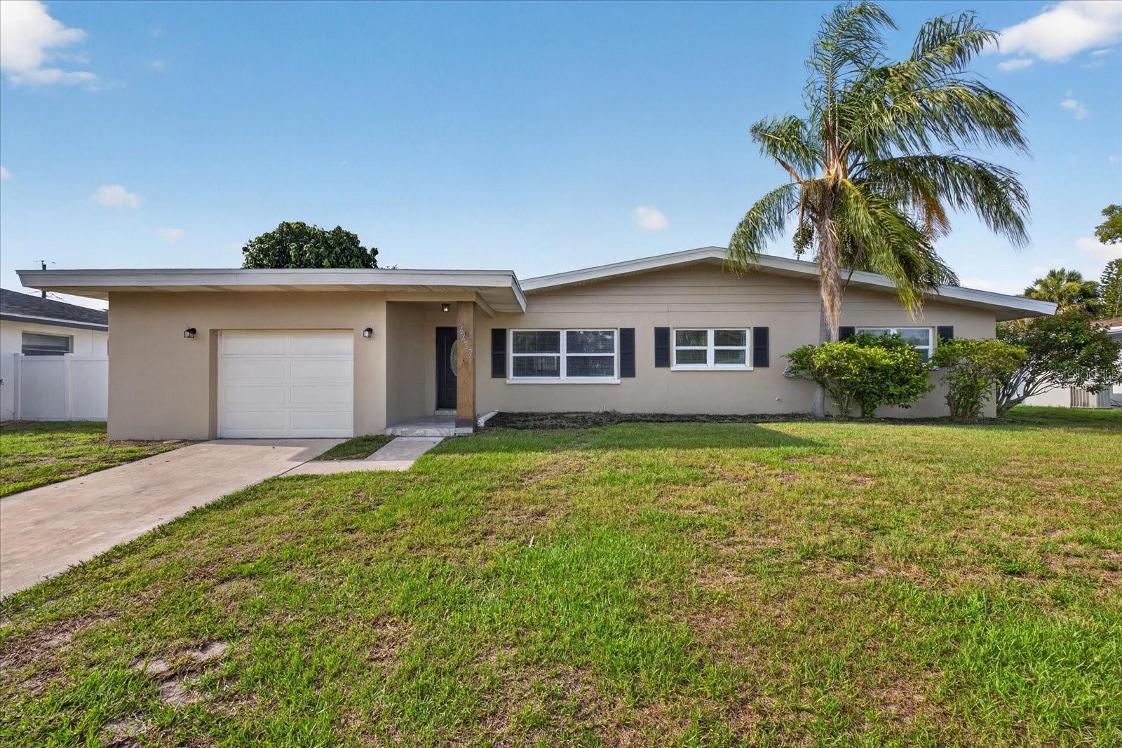 Located in the highly desirable Belleair Bluffs area, this updated pool home offers a spacious single story layout, oversized living areas, and a private backyard setting just minutes from the beaches, Belleair Causeway, waterfront parks, dining, and shopping. RECENT UPDATES INCLUDE A NEW METAL ROOF (2025), AC (2025), WATER HEATER (2026), POOL PUMP (2026), AND STAINLESS STEEL APPLIANCES (2026).

Inside, the home features luxury vinyl plank flooring throughout the main living areas, neutral finishes, recessed lighting, and a functional layout designed for both everyday living and entertaining. The kitchen features granite countertops, white shaker style cabinetry, stainless steel appliances, tile backsplash, a farmhouse sink, extensive cabinet storage, and a large breakfast bar overlooking the main living spaces.

The layout includes multiple living and dining areas with excellent natural light throughout. A spacious family room features a modern fireplace accent wall and French doors leading to the enclosed sunroom with hurricane impact windows overlooking the pool area. The primary suite includes an updated dual vanity bathroom, while the additional bedrooms provide flexibility for guests, office space, or family living.

The backyard is designed for outdoor enjoyment with a screened porch, large patio area, and private in ground pool surrounded by mature tropical landscaping. Additional features include a one car garage and a wide driveway with additional parking.

Conveniently located near Gulf beaches, Belleair Boat Ramp, golf courses, restaurants, shopping, and just a short drive to Clearwater Beach and downtown St. Petersburg.