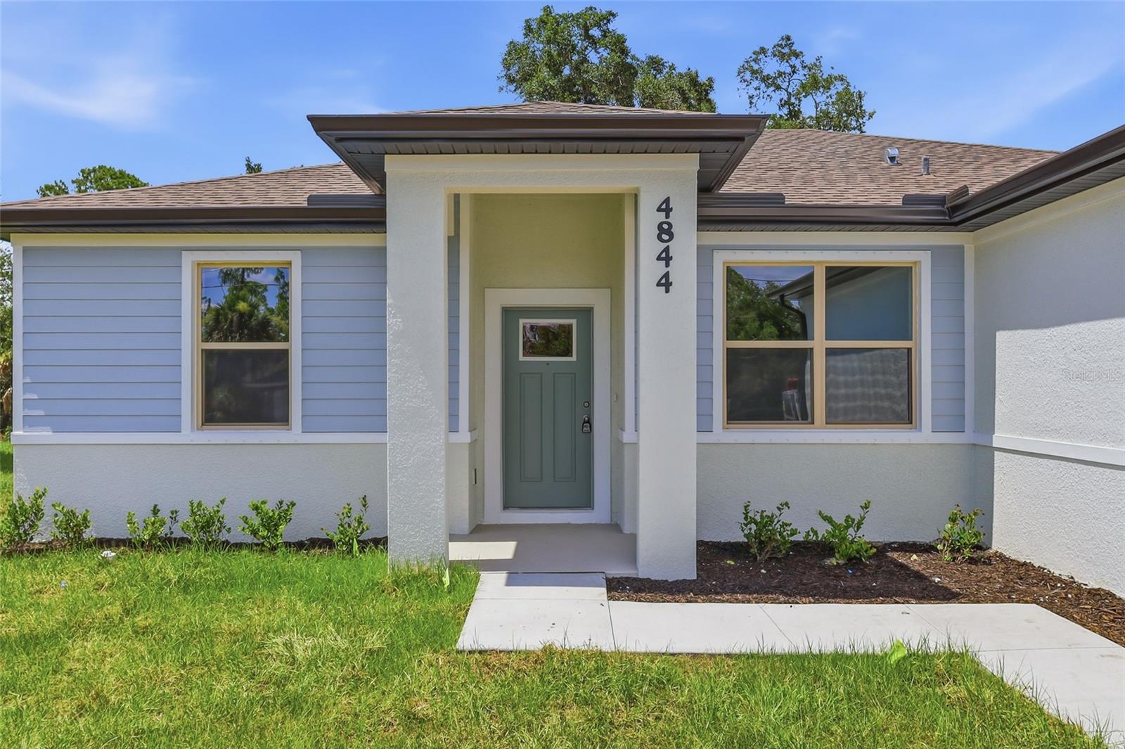 NOW OFFERING 3% TOWARDS CLOSING COSTS WITH PREFERRED LENDER. Great price with luxury features and ready now! A newly constructed home with city water and septic system in North Port, with no HOA fees! Great location for quick access to I-75 off Sumter Blvd. for an easy commute to Sarasota, plus nearby shopping, medical conveniences, parks and schools. You will also be near the City Center for your convenience! This affordable new home is ready for you and is just what you've been looking for...No HOA and with city water! This home has 9'4" tall ceilings, a nice open layout with a versatile floor plan. The house features 4 bedrooms, 2 full bathrooms, dining room, a living room, an open kitchen and a 2-car garage with 1810 square feet of living space. The living space is well utilized with high ceilings and many windows providing natural light. The interior features will provide you with the quality and luxury you were looking for in your new home. This home has a split floor plan with the primary suite on one side of the home and the guest bedrooms on the other. The primary bedroom has a tray ceiling and large windows that bring in lots of natural light. You'll also enjoy a resort-style bathroom with a spacious walk-in shower with tiled walls and a glass enclosure. It also features a linen closet, double vanity and a large walk-in closet. The living room features large windows and several LED fixtures providing plenty of light with access to the covered lanai. The living room is open to the kitchen, where you'll find a huge center island with extra seating for casual dining and plenty of cabinets. The kitchen features stainless steel appliances, Shaker-style cabinets with crown molding, decorative hardware, subway tile backsplash and granite countertops. The dining room is located at the front of the house, with large windows allowing for plenty of natural light. The home includes luxury vinyl plank flooring in the main living areas and bathrooms for durability and comfort. You'll love these floors! They are easy to maintain and offer a modern design, perfect for new homes. Other features include the same beautiful Shaker-style cabinets with hardware and granite countertops in the bathrooms, 5-inch baseboards, a garage door opener, gutters on the exterior, R38 insulation, a 16 SEER HVAC and much more. Visit our model center and compare the features and quality with other homes and you'll see the difference. We make buying easy for you!