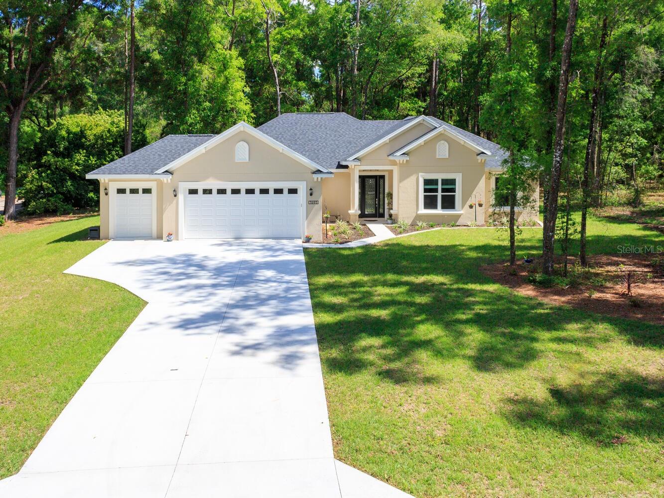 Why wait to build when you can own this better than new home for less than it would cost to build from scratch with the builder! Nestled in the picturesque Rainbow Springs Forest community, this 2023 custom-built home sprawls across 1.07 acres. Boasting 2202 square feet of living space, featuring 3 bedrooms plus a versatile bonus room suitable for a 4th bedroom, office, or craft space, and 2 bathrooms. Upon entry, be captivated by the airy open floor plan, featuring a spacious 16' x 18' living room adorned with stunning 10-foot coffered ceilings. French glass doors beckon towards the screened lanai, offering a panoramic view of the woodlands behind the home—a serene setting for savoring your morning coffee while observing deer near your doorstep. The kitchen is appointed with custom cabinetry boasting soft-close doors, under-cabinet lighting with under-crown molding, granite countertops, tile backsplash, stainless steel appliances, built-in oven and microwave, wine fridge, coffee bar, walk-in pantry, and a dining room. The owner's suite, measuring 19x13, boasts tray ceilings, dual walk-in closets, dual vanities with ample counter space, and a walk-in shower. Guest bedrooms offer generous proportions and ample closet space. The guest bathroom also features custom cabinets, granite counters, tiled shower walls, and a soaking bathtub. The laundry room, measuring 10'x 14', includes a built-in sink and extra counter space for laundry organization. No home would be complete without a 3-car garage, ensuring ample space for vehicles and recreational equipment. The seller has even painted the garage floor with epoxy to make cleaning up any spills a breeze. The home is loaded with upgrades, including tile flooring throughout the main living areas, 6" crown molding, a top-of-the-line whole-house generator with a 250-gallon propane tank, upgraded front door, recessed LED lighting, 8-foot tall interior doors, broom closet with power outlets for charging cordless vacuums. This home's location offers the perfect blend of peaceful country living and convenient access to modern amenities—just 15 miles from Ocala and the renowned World Equestrian Center. Discover the charm of Dunnellon, a town rich in history, culture, and natural beauty. Stroll through its historic streets, browse charming local shops, and experience the breathtaking scenery of Rainbow Springs State Park, where you can float down the world-famous Rainbow River. As a resident, you’ll also enjoy exclusive access to a private beach on the Rainbow River, reserved only for homeowners in the neighborhood. Don’t miss this opportunity—call today to schedule your private showing of this stunning home!