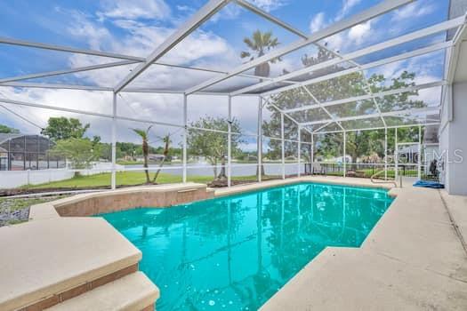 Beautiful, private pool home overlooking small lake with fountain. Cul-de-sac very quiet street.
This home has been updated and completely renovated.  Brand new solid-wood shaker cabinets, quartz counters and upgraded faucets and hardware in kitchen and both bathrooms.  Brand new, top tier engineered wood floors throughout home, all bedrooms and cabana bath. Both bathrooms have dual vanities. 2021 exterior paint and 2025/2026 interior.  
Master bedroom, cabana bathroom and family room all lead out to the screened pool enclosure, where the bugs won't bite as you're watching the 'very best view' of Kennedy Space Center's rocket launches.