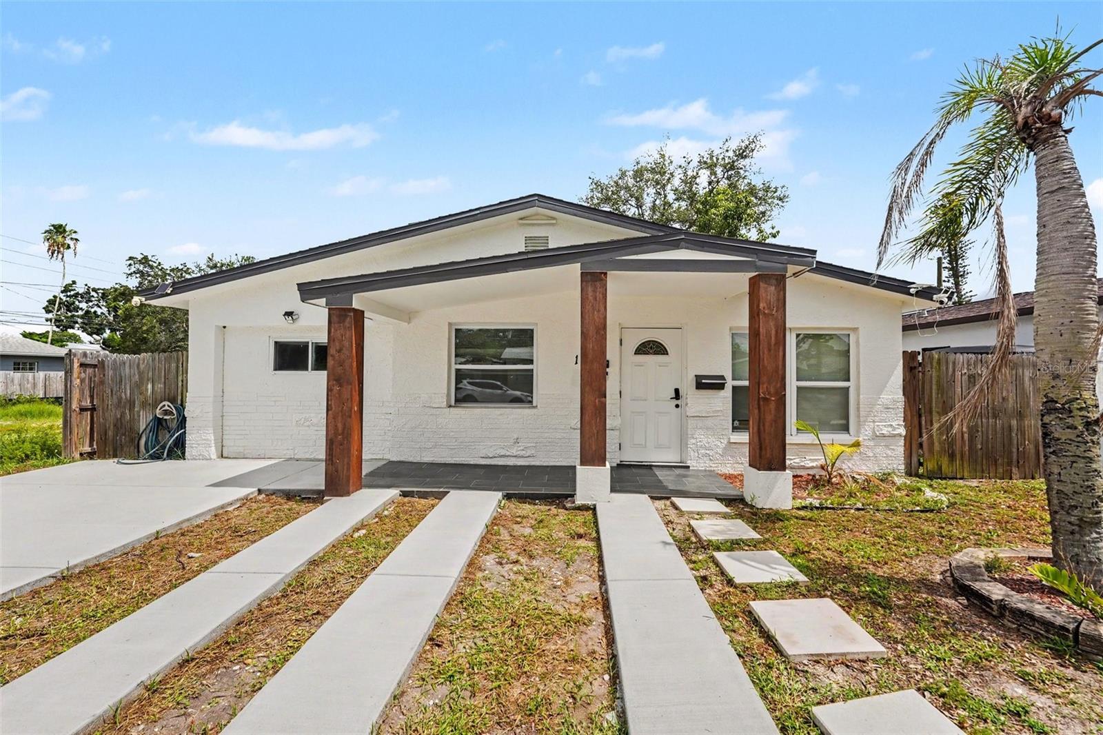 Modern Coastal Living, Fully Reimagined in Shore Acres — 4 Bedrooms, 3 Full Baths
Welcome to a completely renovated, move-in-ready 4-bedroom, 3-full-bath residence where modern minimalist design meets everyday functionality — just minutes from Shore Acres' waterfront parks and the vibrant energy of downtown St. Petersburg. Every detail of this transformation was completed with full City of St. Petersburg permits and inspections, giving you true turnkey confidence with zero HOA restrictions.
Step inside to fresh, light-filled, open and spacious interiors grounded by sleek porcelain tile flowing seamlessly throughout. The heart of the home is a stunning modular-concept kitchen — a chef-inspired design featuring crisp white cabinetry, modern stone countertops, and brand-new stainless steel appliances. Its clean lines and flexible layout elevate everything from a quiet morning espresso to a full evening of entertaining.
The floor plan delivers space and flexibility in equal measure. The primary suite offers a private bath and a generous walk-in closet — a touch of everyday luxury. Two additional bedrooms share a beautifully finished full bath, ideal for family, guests, or a home office. And the fourth bedroom is the true differentiator: a dedicated suite with its own full bathroom and private exterior entrance — perfect as an in-law suite, comfortable guest quarters, a potential efficiency, or a quiet executive office fully separated from the main living areas.
This home is also smarter than it looks. Integrated home automation and smart-home features, along with a security camera system, bring modern convenience and peace of mind. Outside, the expansive backyard is designed for year-round Florida living and already includes irrigation system infrastructure — ready for your garden oasis, weekend barbecues, or simply unwinding. World-class Gulf beaches are just a 10-minute drive away.
Turnkey 4/3 properties offering this level of contemporary design, permitted craftsmanship, prime coastal proximity, and independent living space rarely stay on the market long. Schedule your private showing today and claim your slice of St. Petersburg.