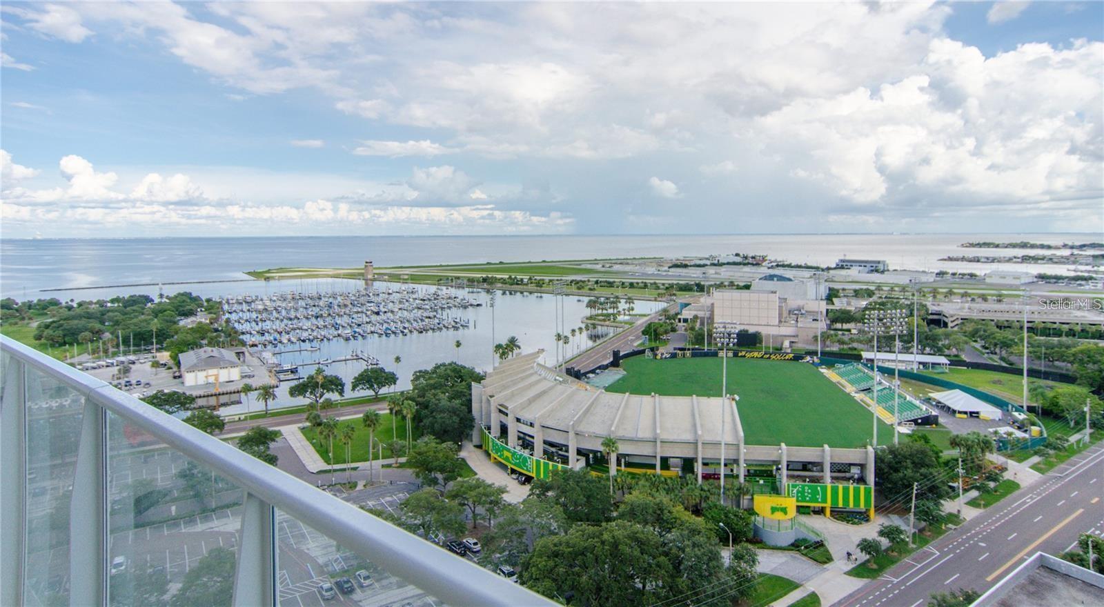 Experience breathtaking southern-facing water views from the 27th floor of one of Downtown St. Petersburg’s most iconic architectural landmarks, widely regarded as a contemporary work of art. This stunning residence offers 2 bedrooms, 2 bathrooms, and 1,447 square feet of thoughtfully designed living space, highlighted by floor-to-ceiling windows with motorized shades that showcase the spectacular scenery beyond. The modern kitchen features sleek European-style cabinetry, stainless steel appliances, and a smooth-surface cooktop. The spacious primary suite includes two generous walk-in closets and a luxurious en-suite bath complete with dual vanities, a glass-enclosed shower, and a relaxing soaking tub. Step onto the private balcony and take in panoramic views of Tampa Bay, the Sunshine Skyway Bridge, the marina, the Rowdies soccer stadium, and the activity of private aircraft at Albert Whitted Airport. These captivating vistas are among the finest available in Downtown St. Petersburg. Located in the heart of downtown, the renowned Signature Place offers an exceptional lifestyle with resort-style amenities including a state-of-the-art fitness center, 24-hour concierge service, heated pool, private cabanas, spa, outdoor grilling areas, and two elegant clubhouse rooms. Enjoy unparalleled walkability to your favorite restaurants, museums, art galleries, Beach Drive, Sundial St. Pete, waterfront parks, The Vinoy Resort & Golf Club, festivals, concerts, and everything that makes Downtown St. Petersburg one of Florida’s most vibrant destinations. This is luxury downtown living at its finest.