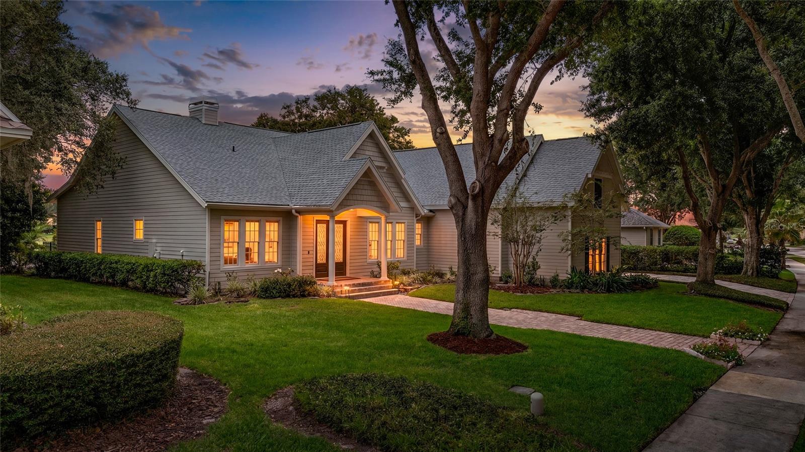 Something unexpected! Something unique! An amazing space!  Welcome to 6241 Blakeford Drive, where the charm, character, and glamour of this custom-built jewel box home are sure to impress. Designed to capture natural light and stunning water views, this residence offers a floor plan that is both functional and unforgettable.  At the heart of the home is a spectacular Great Room featuring soaring 30-foot ceilings
and dramatic picture windows that frame breathtaking views of the pool, pond, and colorful Florida sunsets. Abundant natural light fills the space, creating an inviting atmosphere that seamlessly connects the main living areas.  The thoughtfully designed split floor plan places the spacious primary suite in its own private wing, complete with French doors opening to the pool and a luxurious spa inspired bath showcasing exquisite custom tilework that is truly a work of art. On the opposite side of the home, you'll find a bright office or fifth bedroom with adjacent full bath, an additional guest bedroom, and a rear bedroom overlooking the garden and water, also with convenient pool access. The boutique-style kitchen is a showpiece, highlighted by a dramatic stacked-stone exhaust wall that beautifully complements the matching stone fireplace in the great room. Together, these elements create a warm and cohesive gathering space perfect for everyday living and entertaining. The formal dining room offers flexibility as a sitting room or entertaining space, while the breakfast nook is perfectly positioned to enjoy tranquil pond views and unforgettable sunsets.  Upstairs, a spacious bonus room, fourth bedroom, full bath, and stackable
washer/dryer closet create a private retreat ideal for guests, extended family, or multigenerational living.  Situated on just over one-third acre with 90 feet of waterfront frontage, the property enjoys long pond views and stunning sunset vistas. The oversized three-car garage
and prime location just steps from the Golden Bear Clubhouse add to the home's appeal.  Move-in ready and worry free with new ACs and roof (2024) new quartz countertops (2023 & 2026), new flooring (2023)  and newly painted exterior (2025).