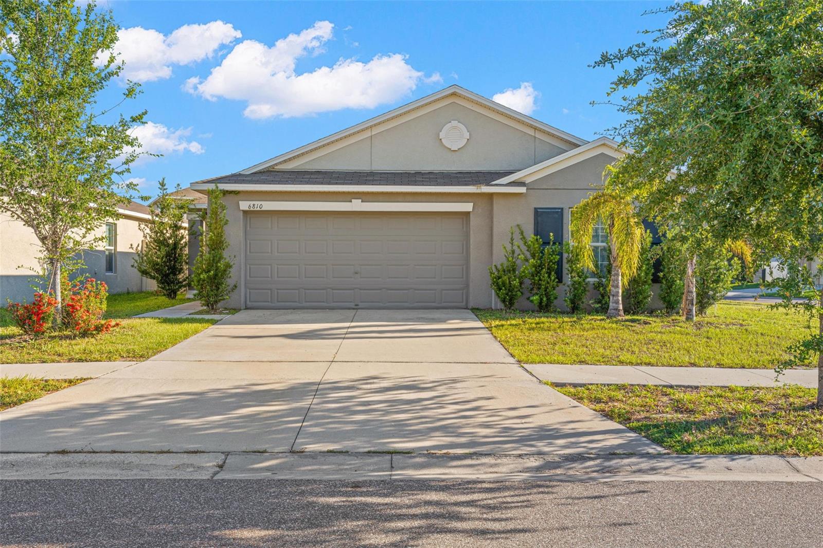 Virtually Staged. Checkout this 2019-built, corner-lot, single-story 4-bedroom, 2-bath home located in Cypress Creek. A split-bedroom layout separates the primary suite from the three other bedrooms, while vaulted ceilings and continuous ceramic tile create one uninterrupted main living space from the great room through the dining area and kitchen.

The kitchen remains connected to the great room without disappearing into it. Espresso cabinetry, granite countertops, recessed lighting, dark appliances, and a walk-in pantry cover the practical side, while the oversized peninsula adds breakfast-bar seating, a double-basin stainless steel sink, generous prep space, and cabinet storage below. The appliance package includes a smooth-top electric range, built-in microwave, dishwasher, and side-by-side refrigerator with ice maker and water dispenser.

Sliding glass doors bring natural light into the great room and open directly to the fully fenced backyard. Long stretches of uninterrupted wall space provide flexibility for larger seating arrangements, a dining area, a media setup, or a combination of all three.

The primary bedroom features laminate flooring, a ceiling fan, neutral tones, and two windows. Its en suite bath includes a granite-topped dual-sink vanity, full-width mirror, cabinet storage, and a tiled walk-in shower with a handheld showerhead. The generously sized walk-in closet is fitted with wraparound shelving and plenty of room for clothing, shoes, and accessories.

Three additional bedrooms each include laminate flooring, ceiling fans, built-in closets, and natural light. The second full bath has a granite-topped vanity and tub-and-shower combination. A dedicated interior laundry room adds tile flooring, upper shelving, and space for full-size appliances.

Outside, the vinyl-fenced backyard leaves plenty of open lawn for pets, gardening, recreation, or future outdoor plans. The corner homesite also provides additional side-yard space and greater separation from the neighboring property. Other features include a front-facing two-car garage, an irrigation system, sidewalks, decorative street lighting, and a Flood Zone X location.

Cypress Creek sits just off I-75 via Big Bend Road, putting Ellenton Premium Outlets, Brandon Town Center, and SouthShore’s broader shopping and dining corridor within easy reach. For time outdoors, E.G. Simmons Conservation Park and Little Manatee River State Park are both nearby, with trails, fishing, and open green space. Schedule your showing today!