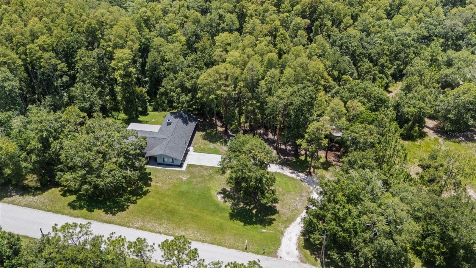 Escape the ordinary without sacrificing convenience! Welcome to 346 Ranch Road, a private 5.69-acre retreat in the highly desirable Keystone Ranchettes where peaceful country living meets the Florida's Gulf Coast lifestyle. Situated among some of Keystone Ranchettes' most impressive estate homes, with most neighboring properties valued at over $1 million. Professionally decorated and thoughtfully refreshed, this property offers buyers a fresh new look with additional land clearing that showcases more of the usable homesite while preserving the beauty and privacy of the surrounding woods.

Whether you're searching for a family estate, horse property, private homestead, multigenerational living, or an income-producing investment, this one-of-a-kind property offers endless possibilities.

This tastefully updated 4-bedroom, 3-bath home features spacious living areas, an open floor plan, a wood-burning fireplace, quartz countertops, shaker cabinetry, stainless steel appliances, and an oversized 2-car garage. The primary suite opens to the covered patio, creating the perfect place to enjoy peaceful mornings overlooking your private outdoor sanctuary.

Outside, the opportunities continue. The existing 4-stall stable is ideal for horses or could be transformed into a workshop, hobby space, or future barn with guest quarters or an apartment (subject to county approval). There's plenty of room for a pool, RV, boat, trailers, and all your recreational toys.

Approximately 1.3 acres are buildable, providing generous space for outdoor living and future improvements, while the remaining wooded acreage creates your own private nature preserve. Deer and other native wildlife are frequent visitors, while the wooded acreage offers the perfect setting for walking trails, ATV adventures, dirt bikes, or simply enjoying the peace and privacy that make this property so special. A picturesque seasonal creek meanders along the southern edge of the property, adding character, natural beauty, and an additional layer of privacy to this peaceful natural setting.

Located in unincorporated Pinellas County, short-term rentals are permitted, making this an exceptional opportunity for Airbnb, vacation rental, or multigenerational living.

One of this property's greatest surprises is its location. Although it feels miles away from everything, you're only about 15 minutes from Fred Howard Park, Sunset Beach, and the historic Tarpon Springs Sponge Docks; approximately 20 minutes to Downtown Dunedin; about 30 minutes to Clearwater Beach; and roughly 35 minutes to both Tampa International Airport and St. Pete-Clearwater International Airport. Shopping, dining, golf, parks, medical facilities, and top-rated schools are all nearby.

For added peace of mind, the home previously experienced soil settlement at the rear of the property. The foundation has since been professionally reinforced and stabilized by a licensed foundation repair contractor, and the repair includes a transferable lifetime warranty.

Properties offering this combination of acreage, privacy, flexibility, investment potential, and proximity to Florida's Gulf Coast are becoming increasingly rare. Whether you envision a private family retreat, an equestrian lifestyle, a weekend getaway, or a high-demand short-term rental, this exceptional property offers the freedom to make it your own.