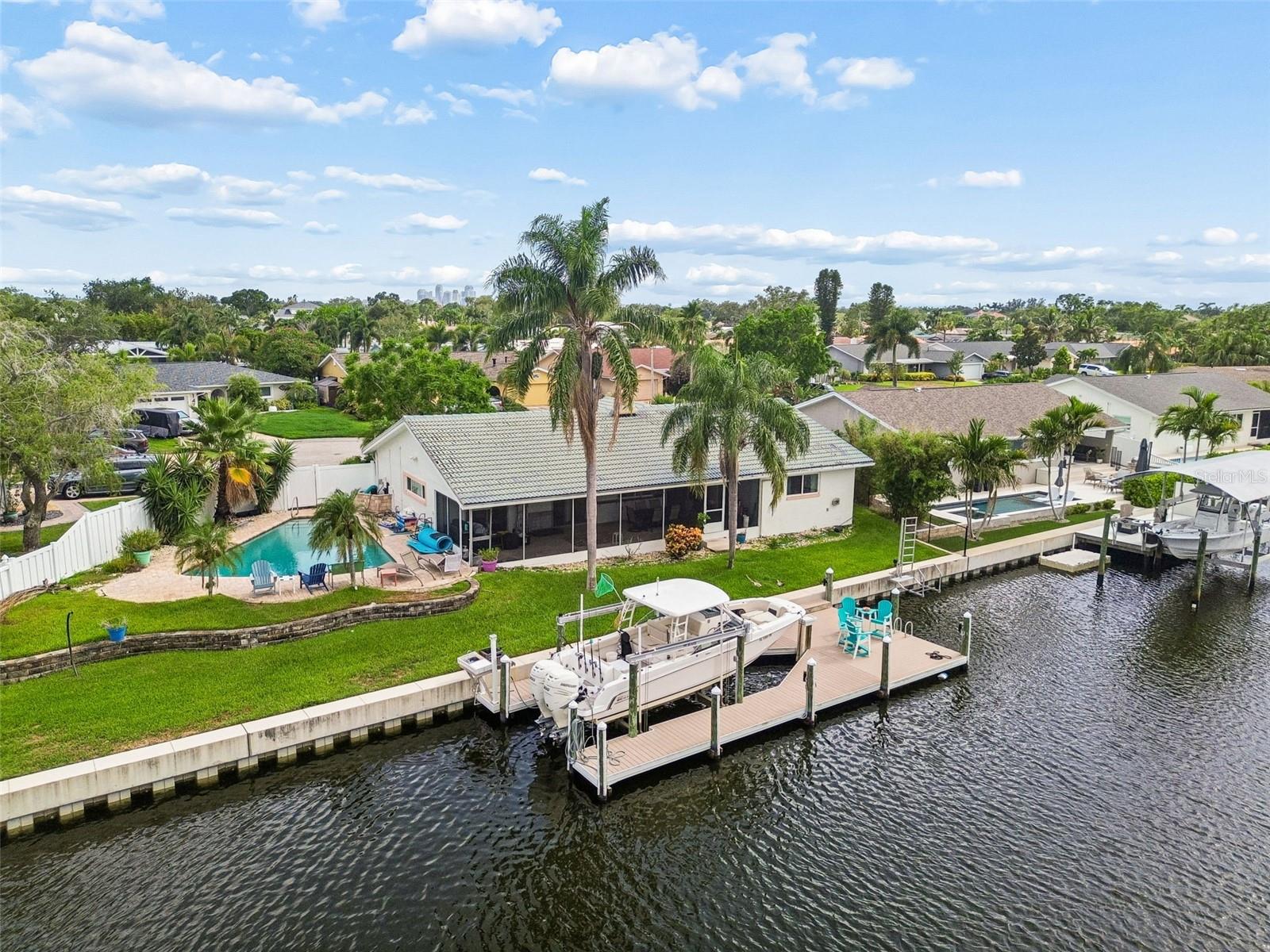 Waterfront Paradise in Highly Sought-After Ponderosa Shores!

Never Flooded! This home stayed high and dry through out all hurricanes!

Welcome home to this beautiful waterfront retreat located on a quiet cul-de-sac in one of St. Petersburg’s most desirable neighborhoods. Sitting on an expansive lot with ~140 feet of prime saltwater canal frontage, this home offers breathtaking views up the canal and effortless access to Tampa Bay and the Gulf of Mexico.

Step inside this move-in-ready 3-bedroom, 2-bathroom home where waterfront views meet relaxed Florida living. Sliding doors and windows open to the expansive 500 sq ft screened lanai, perfect for seamless indoor-outdoor entertaining.



The split-bedroom floor plan provides privacy, with the spacious master suite featuring an oversized walk-in closet with custom shelving and a stunning contemporary en-suite bath complete with double under-mount sinks, quartz counters, and custom wood cabinetry. Both bathrooms have been tastefully remodeled with modern finishes. Beautiful wood flooring flows through the bedrooms and select living areas, complemented by durable tile in high-traffic zones.



The backyard is an entertainer’s dream: a fully renovated heated saltwater pool, newer composite dock with 13,000 IB Boat lift (easily accommodating a 30-ft boat), built-in sink with electric and water, and a separate kayak lift. Impact-rated windows, hurricane protection, newer HVAC, Newer seawall, custom wrap around dock and extensive exterior improvements ensure a great place for outdoor entertaining.



Recent updates include: impact windows, composite dock, seawall, pool renovation & heater, bathrooms, HVAC/ductwork, insulation, paver driveway, exterior paint, landscaping, and more.

Located minutes from vibrant 4th Street, downtown St. Petersburg, and all the dining, shopping, and entertainment the area has to offer — yet tucked away in a peaceful waterfront setting. 

Whether you’re looking for the ultimate Florida lifestyle, a boater’s haven, or a turnkey investment property, this rare waterfront gem checks every box. Schedule your private showing today and make this slice of paradise yours!