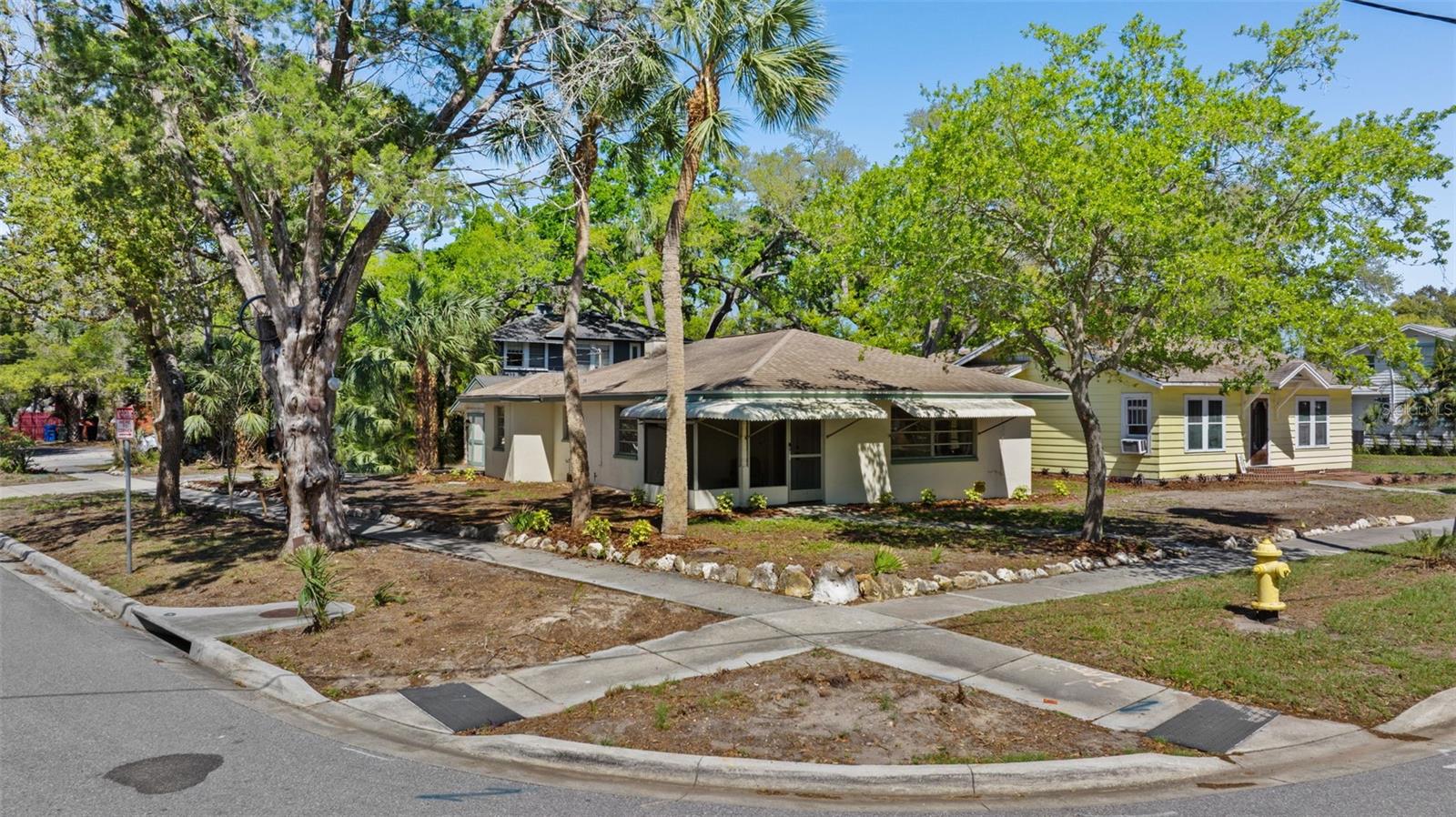 Virtually Staged. Iconic Downtown Opportunity | Live, Invest, or Create Your Dunedin Compound
Positioned at the corner of President St and Broadway St., this exceptional 0.53-acre property offers a rare opportunity in the heart of Dunedin. Just steps from the Pinellas Trail, two blocks to the marina, and a short stroll to Main Street’s renowned dining, shops, and waterfront, this location delivers the ultimate blend of charm, walkability, and lifestyle.
Zoned MF-7.5 with potential for up to four residential units, the property presents a unique canvas for a luxury compound, boutique development, or thoughtfully designed multi-residence retreat. Whether envisioned as a private family estate with guest homes, a seasonal coastal getaway, or a long-term hold with income, the flexibility here is what makes it special.
Three points of access (President St, Broadway, and rear alley) provide a level of optionality rarely found in downtown parcels—ideal for both future development and functional day-to-day living.
The grounds are anchored by majestic century-old Live Oaks, creating a timeless Old Florida setting that enhances both privacy and character. Existing improvements include one income-producing structure: a well-maintained 2BR/1.5BA ranch with terrazzo floors, offering immediate cash flow, multigenerational living, or the ability to live on-site while designing your vision.
Located in a sought-after golf cart district near TD Ballpark and the Dunedin Marina, this is a premier offering for those seeking a signature property in one of Tampa Bay’s most desirable coastal communities. The location is A+++ and demand for well-executed new construction in downtown Dunedin continues to grow. 
No short-term rentals permitted in this neighborhood. Buyer to verify all zoning, use, and development details.