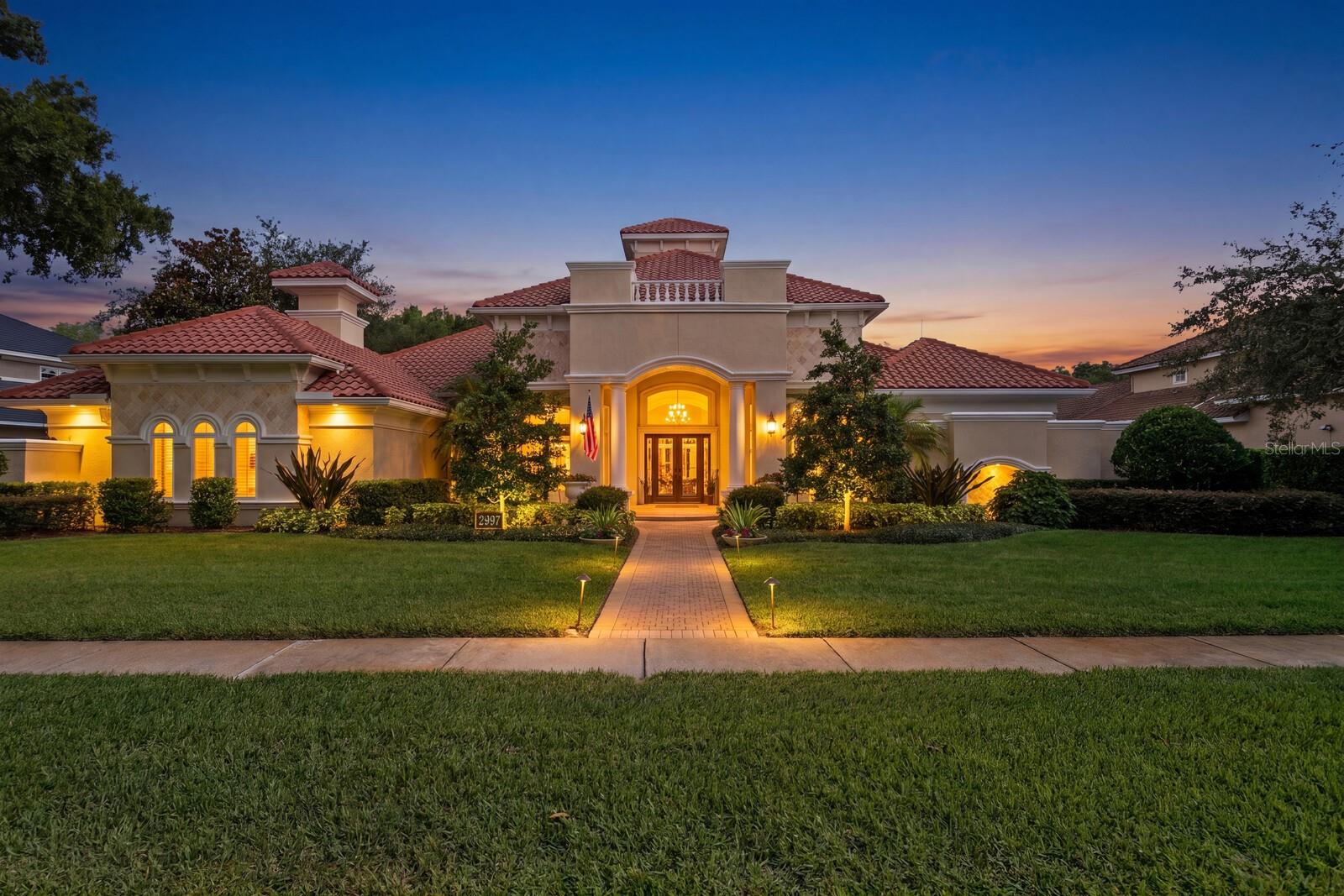 Welcome to an extraordinary, meticulously maintained home priced to sell! This beautiful home combines timeless elegance with unparalleled craftsmanship featuring 5-bedrooms, 4.5-baths.  Offering luxury at every turn, exquisite travertine flooring, granite counter tops, wine cellar, in-home gym, soaring ceilings, intricate decorative touches throughout. At the heart of the home lies an impressive chef's kitchen, thoughtfully designed for both culinary excellence and effortless entertaining, seamlessly connecting to the surrounding living, entertainment and dining areas while showcasing the expansive lanai, where indoor and outdoor living blend seamlessly. Enjoy a sparkling pool and spa, outdoor kitchen, and your very own lighted putting green, or retreat to the billiards room, all perfectly positioned to capture serene lake and conservation views.  Three ensuites and a  jack and jill equals five thoughtfully designed bedrooms with comfort and privacy in mind. The luxurious primary suite offers a private sanctuary, while the home's thoughtfully curated living spaces provide elegance, comfort, and flexibility for both everyday living and grand-scale entertaining. The home's impressive elevation, stately presence, paver-stone driveway, exceptionally manicured landscaping create a grand first impression. And don't miss the whole-home generator to keep you comfortable at all times in case of a power outage. Nestled beyond the 24/7 guarded entry of Wentworth. Only 30 minutes to Gulf Coast's finest beaches and Tampa International Airport and just minutes more to Downtown Tampa. Conveniently located to nearby grocery, dining, entertainment and famous Tarpon Springs sponge docks.