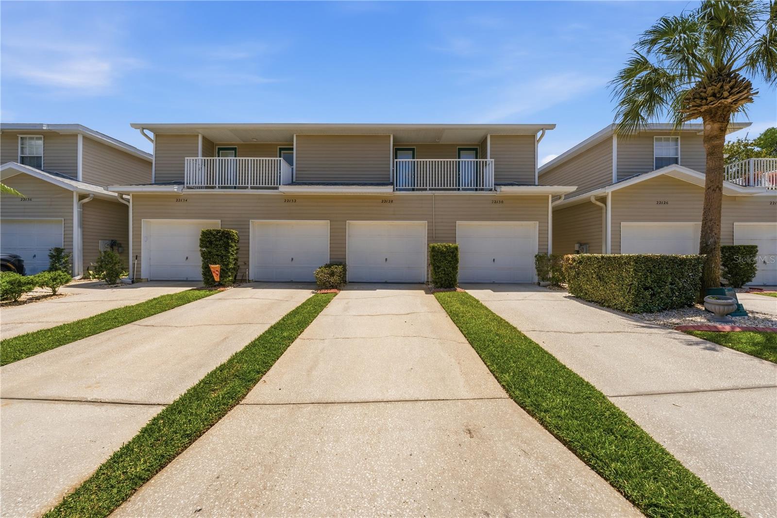 **Free 1% one-year interest rate buy down through use of seller's preferred lender**  Discover your perfect Florida retreat at 22128 Little Lagoon Court N in the desirable gated community of Lakes at Heron Cove in Lutz, Florida. This beautifully updated first-floor 2-bedroom, 2-bathroom condo boasts 1,166 square feet of bright, open living space and includes the rare luxury of a private 1-car attached garage.

The thoughtful split-bedroom layout ensures maximum privacy, while the expansive living and dining areas create an ideal setting for both relaxed everyday living and effortless entertaining. Your screened lanai offers peaceful conservation area views with frequent visits from local wildlife, making it the perfect spot for morning coffee or unwinding at sunset.

The chef-friendly kitchen shines with generous counter space, a convenient breakfast bar and updated Stainless Steel appliances. The generous primary suite (15x13) features an oversized walk-in closet and a luxurious en-suite bath complete with his and hers dual vanities, walk-in shower, and private water closet. Tile flooring and vinyl flooring throughout the main living areas adds durability and ease, while quality carpet in the bedrooms provides comfort underfoot.

This home has been thoughtfully maintained with impressive recent UPDATES, including a new HVAC system installed in 2022, impact-rated hurricane windows and sliding doors throughout, and a recently updated water heater. The community roof is fully covered by the HOA, adding even more peace of mind. Best of all, there are no CDD fees and the monthly HOA is $449 per month, delivering outstanding value and true low-maintenance living.

Enjoy a resort-style lifestyle with a sparkling pool, hot tub, clubhouse, scenic walking trails, and direct access to beautiful 54-acre Lake Bird featuring a boat ramp and fishing dock—perfect for kayaking, small boats, or quiet days on the water. Tucked away yet conveniently located just off Hwy 54 with easy I-275 access, you’re minutes from shopping, dining, and top-tier amenities, with USF, Moffitt Cancer Center, and Downtown Tampa all within a short 20–30 minute drive.

This move-in ready, turnkey condo is truly one you don’t want to miss.  **Free 1% one-year interest rate buy down through use of seller's preferred lender**