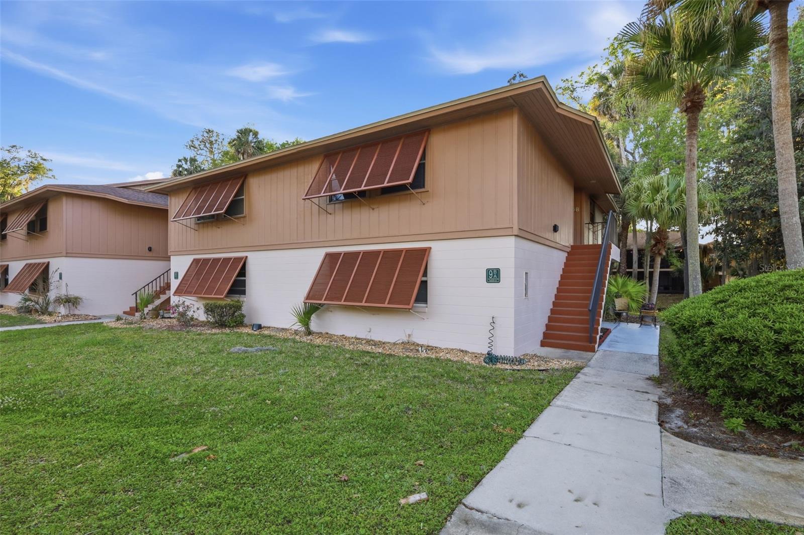 Nestled within the serene Edgewater Condominium community, this charming 2-bedroom, 2-bathroom with a covered and screened rear porch on the 2nd floor.  This residence offers 897 sq ft of comfortable living in a peaceful, park-like setting.  Step inside to find new fresh paint along with brand new vinyl flooring throughout. The living and dining spaces flow seamlessly—ideal for entertaining or relaxing.  Outdoor enjoyment is at its best with a screened-in balcony overlooking lush landscaping—perfect for morning coffee or unwinding at day’s end.  The owner's suite includes a bath with a tub/ shower.  Condo includes closet laundry with a stacked Washer/Dryer unit.  Edgewater Condominium residents enjoy excellent amenities—including a sparkling swimming pool and well-kept tennis/pickleball courts -- with easy access to the scenic walking and biking trail, Green Springs Park, and nearby Lake Monroe, private parking space, and guest parking.  Buyers must be approved by the association, No pets allowed.  Location is a true highlight: mere minutes from I-4, public transit routes, SunRail station, Sanford/Orlando Airport, grocery stores, medical facilities, and nearby schools.  With a reasonable monthly HOA of $217, covering exterior and grounds maintenance, irrigation, reserves, and on-site management. This condo offers a worry-free lifestyle in a coveted Deltona neighborhood.  Enjoy peaceful, easy Florida living with endless amenities and strong connectivity. Don’t miss your chance—schedule a showing today!