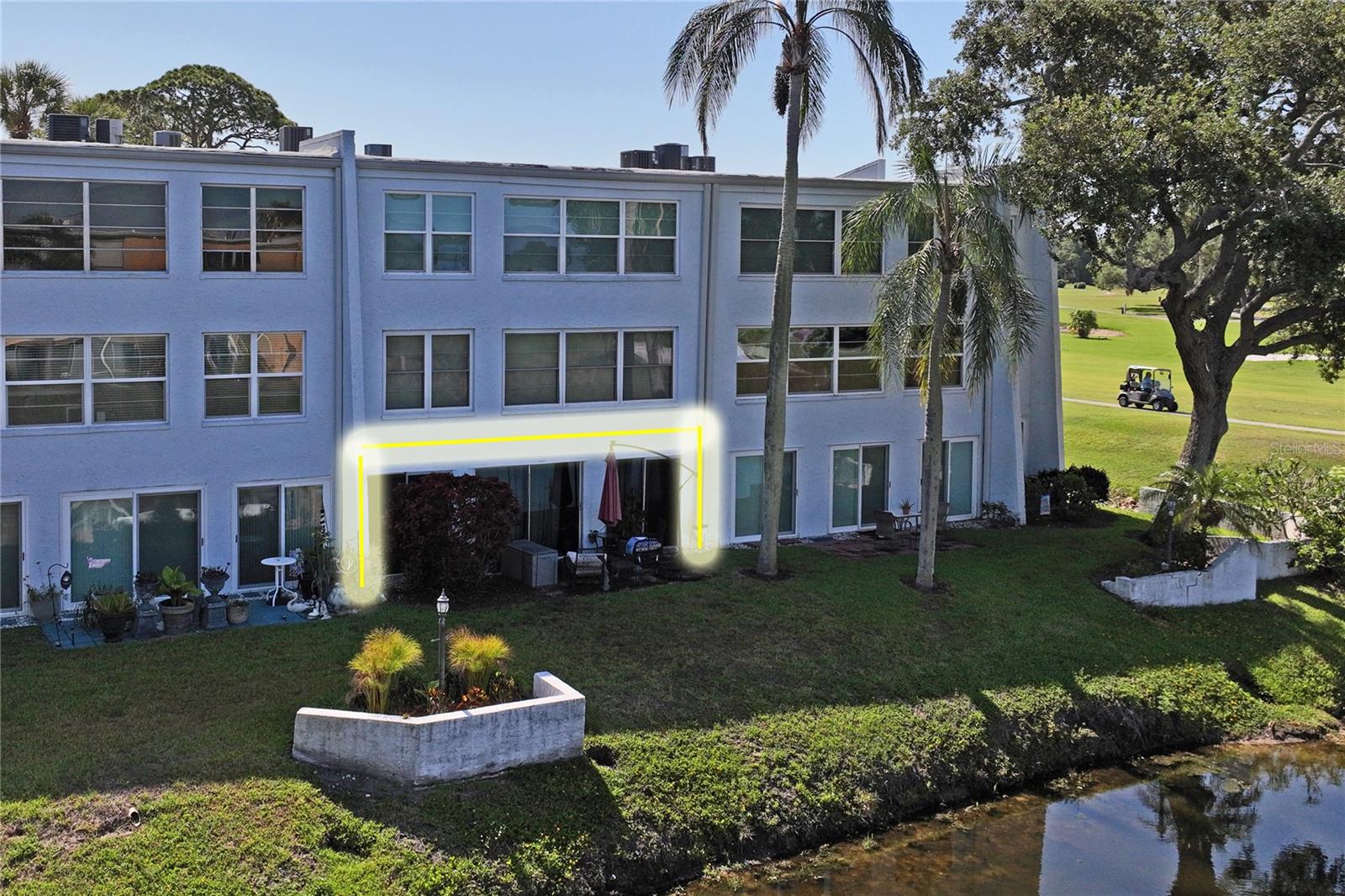 Updated S P A C I O U S ground floor condo situated right on a pond with golf course views as well. 55+ community with one small pet allowed. One assigned carport right out front with tandem parking allowed and separate guest parking is available. Luxury waterproof vinyl plank flooring installed throughout. Stunning recycled glass counter tops in white, blue & silver complement stainless steel Appliances. Gorgeous soft close cabinets and drawers in platinum tone, with a reflective, easy-clean surface complete the look of this kitchen. Both Bathrooms have been beautifully updated.  New Hot Water Tank. HVAC Serviced.  Florida Room and Dining Area overlook the pond and golf course you can relax and enjoy that morning cup of coffee. Open pond and golf course views are also available from every part of the common area of this condo. It's like a full width picture window giving colorful sunsets views every evening. The large utility/laundry room doubles as a kitchen pantry. Washer and dryer will convey a long with the two bedroom TVs.  Another large storage closet in accessed from the hallway. HUGE master closet. Updated electrical panel. Condo fee covers water, trash, insurance, basic cable TV, exterior maintenance, reserves, and small land lease for the community pool and clubhouse. Great Largo location with easy access to shopping, and world famous beaches.