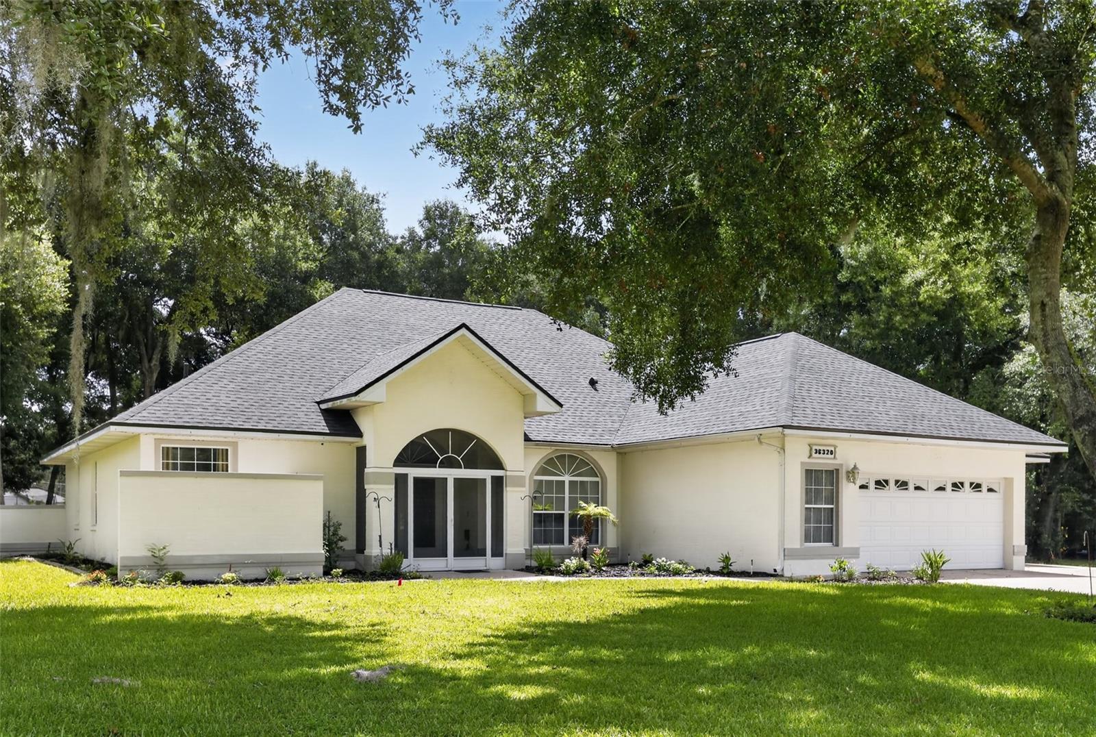 New Price: $499,000! Previously listed at $584,000. An incredible value and one of the better opportunities in the area. Here are the details of this spacious and stately home in the desirable Spring Lake Pines subdivision. This well-cared-for executive home sits on a 3/4 acre lot and features a three-car garage with an additional parking pad. The interior offers an open floor plan with soaring ceilings, a grand living room, and a formal dining room with beautiful pendant lighting. The kitchen is equipped with ample white cabinetry, a breakfast bar, and included appliances. The primary suite features double walk-in closets and an en suite bath with a jetted garden tub and step-in shower. Two additional bedrooms are located on the opposite side of the home for added privacy. The outdoor space is a private haven, featuring a screened front entrance, a fenced backyard, and a covered lanai. The lanai serves as a perfect gathering space with a half-bath, an outdoor shower, and a hot tub. Key updates include a new roof (2024), a PVCC fence, and an extensive sprinkler system. With low HOA fees, reasonable taxes, and a recently reduced price, this home is ready for its next owner. Schedule your showing today!