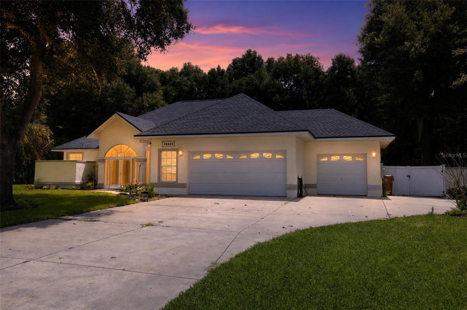 Here are the details of this spacious and stately home in the desirable Spring Lake Pines subdivision. This well-cared-for executive home sits on a 3/4 acre lot and features a three-car garage with an additional parking pad. The interior offers an open floor plan with soaring ceilings, a grand living room, and a formal dining room with beautiful pendant lighting. The kitchen is equipped with ample white cabinetry, a breakfast bar, and included appliances. The primary suite features double walk-in closets and an en suite bath with a jetted garden tub and step-in shower. Two additional bedrooms are located on the opposite side of the home for added privacy. The outdoor space is a private haven, featuring a screened front entrance, a fenced backyard, and a covered lanai. The lanai serves as a perfect gathering space with a half-bath, an outdoor shower, and a hot tub. Key updates include a new roof (2024), a PVCC fence, and an extensive sprinkler system. With low HOA fees, reasonable taxes, and a recently reduced price, this home is ready for its next owner. Schedule a viewing soon!