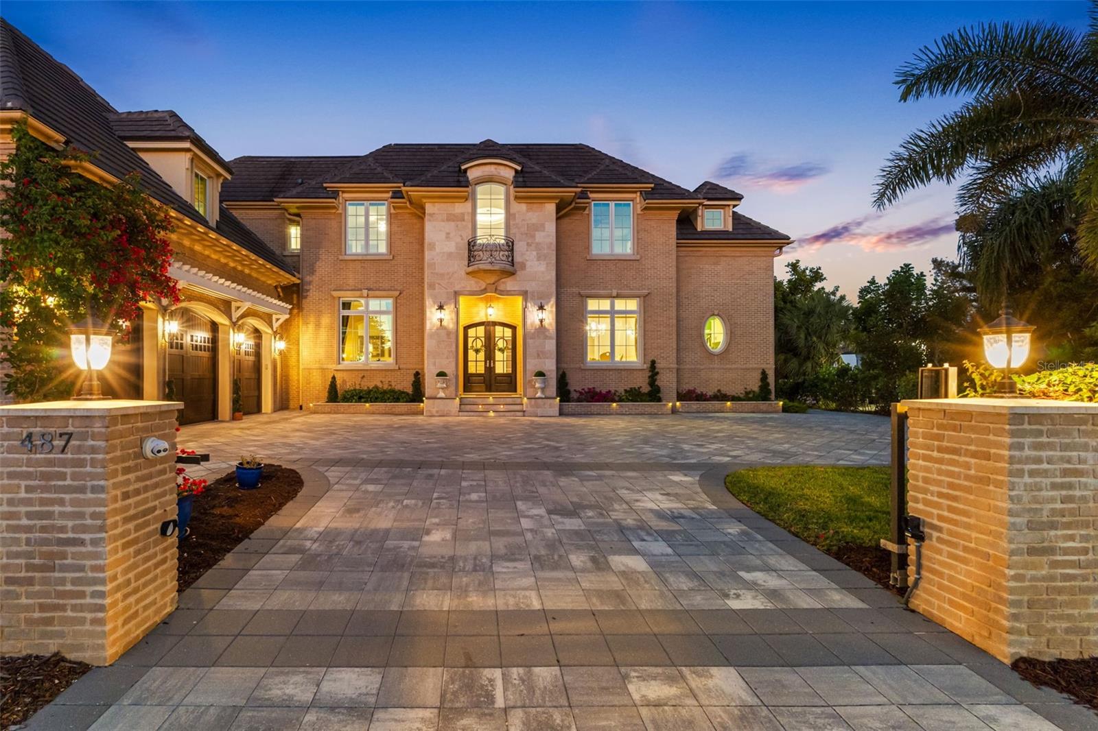 Located on Bird Key, a gated community, one of the most sought-after island addresses in Sarasota, this exceptional custom-built French Country Style waterfront estate, built in 2021, offers the ultimate in luxury coastal living. 
The location is perfect, between Downtown Sarasota, St. Armands Circle, and Lido Key Beach, this amazing residence sits on 135 feet of premier Sarasota Bay frontage with breathtaking wide-open water views and stunning city skyline vistas. This home features an abundance of natural light in every room.
Designed for both elegance and functionality, this home offers 5 spacious en-suite bedrooms, including a luxurious first-floor primary suite with a spa-inspired bath. 
Deep boating waters with no bridges to the Gulf make this property a dream for boating enthusiasts, complete with a private dock and a 24,000-pound boat lift. Outdoor living is elevated with a large, heated saltwater pool featuring a tanning deck, umbrella holder, spa, and expansive entertaining areas. 
Multiple oversized patios on each floor, a rooftop deck/crow’s nest, and a fully equipped outdoor kitchen with a poolside half bath accessible from both inside and outside create the ideal setting for entertaining and enjoying spectacular sunsets over Sarasota Bay. 
Inside, sophistication continues with a formal dining room, private office, expansive game / entertainment room with guest bath, and a beautifully finished elevator with rich wood paneling and tile flooring and a kitchen that is every chef’s dream, Wolf appliances, Subzero fridge, 2 dishwashers, granite countertops and breakfast nook. 
Additional luxury features include hurricane-rated 8 foot windows and doors, generator, 3-car garage with Tesla EV charging station, and high-end finishes throughout. 
Residents of Bird Key enjoy an exclusive private island lifestyle with deep-water canals, bayfront estates, the renowned Bird Key Yacht Club, and quick access to world-class dining, shopping, arts, golf, tennis, and the renowned The John and Mable Ringling Museum of Art, and award winning white sandy beaches. Bird Key and Sarasota have long attracted high-profile residents including Brian Johnson, Jerry Springer, Martina Navratilova, Lucille Ball, Stephen King, Joe Perry, Dick Vitale Bird Key is more than an address—it is a statement of prestige, privacy, and paradise. Call today for your private showing.