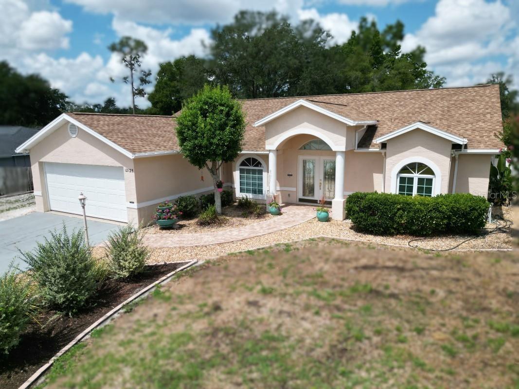 Welcome to a beautifully maintained 3-bed, 2-bath home that truly feels like a retreat — perfect for families, retirees, or anyone looking for comfort and space. Built in 2002 with solid concrete block and stucco construction, this home sits on a rare 0.42-acre lot in the heart of charming, old-Florida San Antonio. Step inside to an open-concept layout featuring a bright kitchen with quartz countertops, a welcoming dining area, and a spacious living room ideal for gatherings. Double French doors connect the living room and primary suite to the expansive air-conditioned Florida room, offering nearly 12 feet of open access to the fully screened-in pool area — perfect for relaxing, entertaining, or enjoying the Florida sunshine year-round. The primary suite includes a generous walk-in closet, updated cabinetry, and a beautifully finished bathroom with a large, inviting shower. This home is designed for comfort and efficiency with central HVAC, a split system heat pump, electric backup heat, 10 ceiling fans, dual-pane windows, and extra attic insulation. Fresh interior and exterior paint, along with durable laminate and tile flooring, make it move-in ready. Outside, the fully fenced backyard offers a low-maintenance, water-conserving landscape, plus space for gardening, a storage shed, and parking for a lawnmower or tools. There’s plenty of room for a fishing boat or utility trailer, plus off-street parking for 4+ vehicles. The home also includes an enclosure for a backup generator with a 50-amp temporary input option. Enjoy peace of mind with a top-quality GAF asphalt shingle roof (2019) and the convenience of an attached 2-car garage. HVAC sqft is 1609 as reflected in public record, however, actual HVAC sqft is 1951 due to Florida room HVAC install. Located just 35 miles north of Tampa, this quiet neighborhood offers quick access to I-75, Publix, restaurants, the post office, and more. Saint Leo University and beautiful Lake Jovita are only a mile away, and several AdventHealth hospitals are within a short drive. City water here is known for being exceptionally clear and great tasting. This is a rare opportunity to own a spacious, well-cared-for home in one of Florida’s most charming small towns.