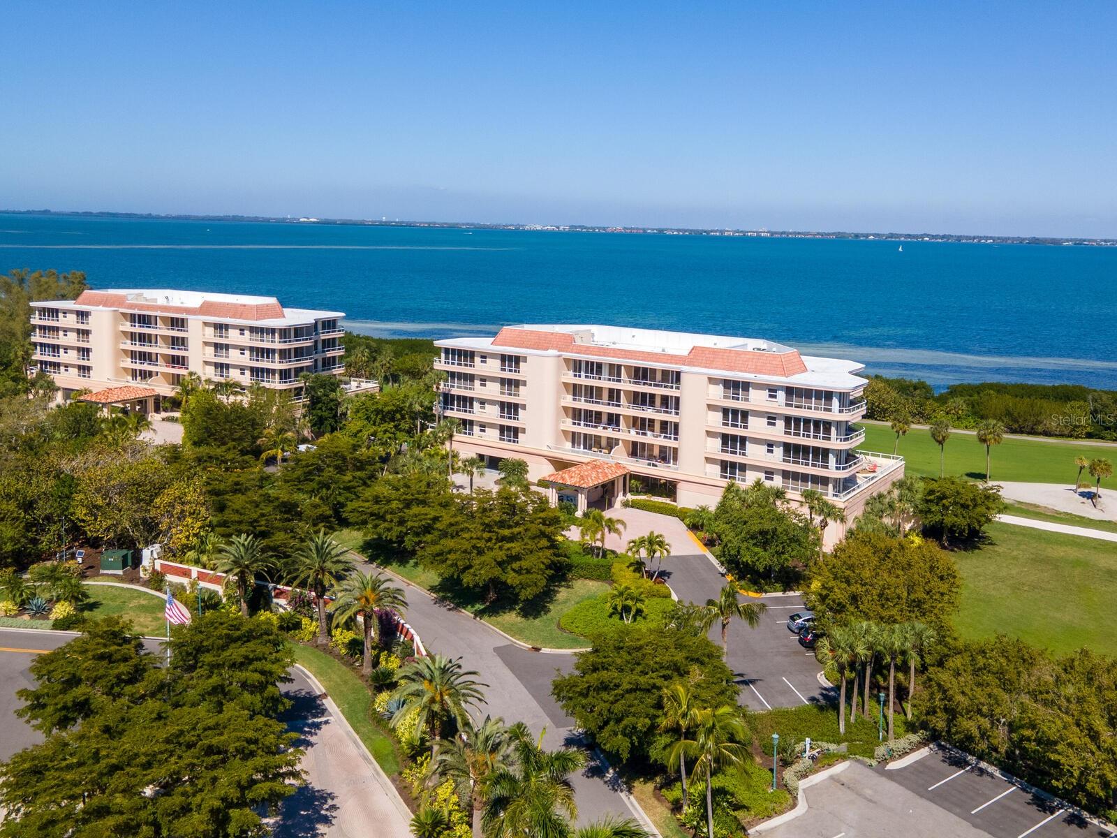 Move in ready and beautifully updated two bedroom two bath Bimini model in Grand Bay nestled within the secure gated enclave of Bay Isles. Located on the third living level of the four level over parking building 6, you will enjoy panoramic views of Sarasota Bay as you gaze out from your almost 400 foot wrap around terrace offering sunrise and sunset views. This particular condo has been tastefully updated with new variable speed HVAC  with humidity control, Wi-Fi Thermostat & 12 year warranty on compressor in 2024; new water heater & significantly updated kitchen in 2026; new refrigerator, washer & dryer, Hunter Douglas battery operated remote-controlled window treatments, lighting & plumbing fixtures & freshly painted all in 2023. Nothing more to do but to move in and enjoy everything Grand Bay, Longboat Key and Sarasota have to offer especially with the recently renewed transferable Home-Tech service contract! Your amenities include two large resort style heated swimming pools and spas, tennis courts, state of the art fitness center and expansive clubhouse with social activities as well as access to the private white sandy well maintained beach at the Bay Isles Beach Club on the Gulf of Mexico. You will also have access to beautiful peaceful walking trails winding along the bay front, marina and golf courses. A short drive will lead you to choice eateries along Gulf of Mexico Drive or over the bridge to St Armands Circle and downtown Sarasota.