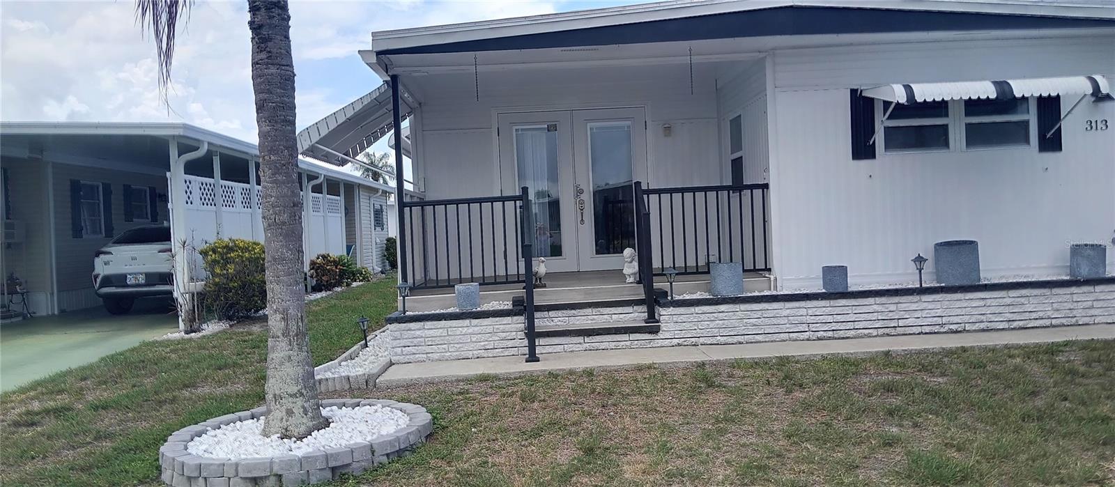 A Beautiful place to call home! This LOVELY 2 bedroom /2 bath totally redone home is move in ready! Step inside to the spacious Dining/ living room area with plenty of room for family gatherings and meals with friends.Spacious kitchen with movable island, stainless steel appliances and side by side refrigerator/ freezer.As you head down the hallway you will encounter Two spacious bedrooms with plenty of storage, walk in closets and beautiful flooring! Step back outside and you will encounter an enclosed breezeway which has space for additional storage and a HUGE workshop with plenty of shelving, lights and a large workbench;  laundry room with stackable washer/ dryer with shelving and plenty of room to hang clothes and.... another extra room to your left! OTHER VALUABLE nuances with this home are: NEW  A/C 2021 WITH NEW HEATING ELEMENT 2025; REVERSE OSMOSIS SYSTEM;SHUT OFFS FOR ALL WATER SYSTEMS; SEWER DONE TO MAIN SEWER LINE and a 2019 water heater with on demand hot water system. There is an extra storage closet in the hallway and a motion sensor light between bedrooms.  Enjoy the heated resort style pool area that features a new bath house and activity court all within a few steps from this home! You will love this 55 and up community in CHATEAU VILLAGE and the folks that live here!
