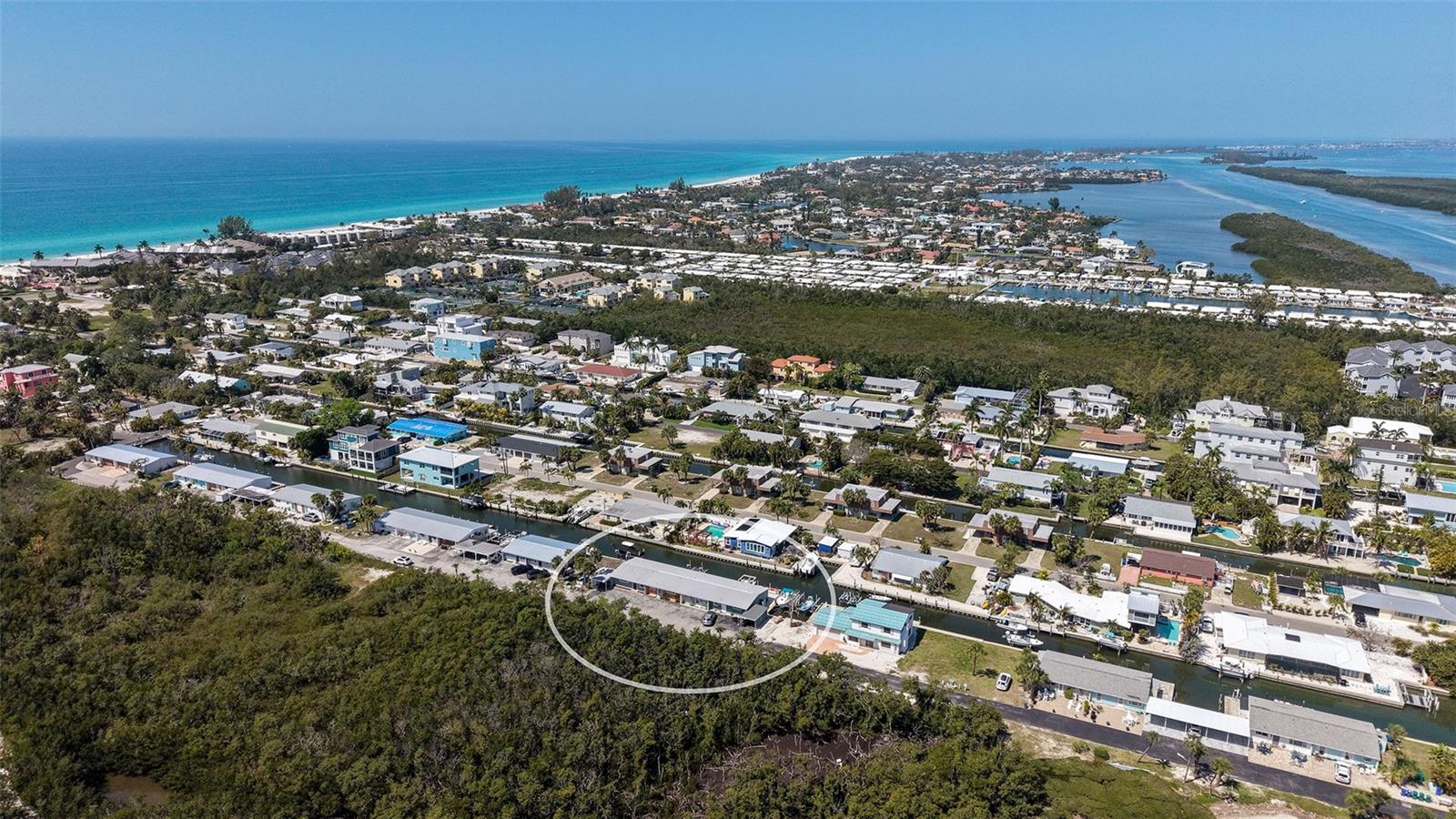 Live that Longboat Key waterfront lifestyle and have your own boat lift without the multi-million dollar price. Cute and conveniently located, this on-grade one bedroom condominium unit that is located on a saltwater canal on Longboat Key, features its own 10,000 lb boat lift, and is one block to the gulf beaches and adjacent to Durante Park. Everything new in 2025, including a washer and dryer and hot water demand unit. The condo is completely furnished with an updated living space, complete with open kitchen that features granite countertops, stainless steel appliance and plenty of storage. The modern wood-look tile and updated sliders and windows make for an open feeling living area.  There is a paver patio and dock behind the condo for enjoying the sunsets on the canal. A number of shops and restaurants within walking distance.  Schedule your showing today!